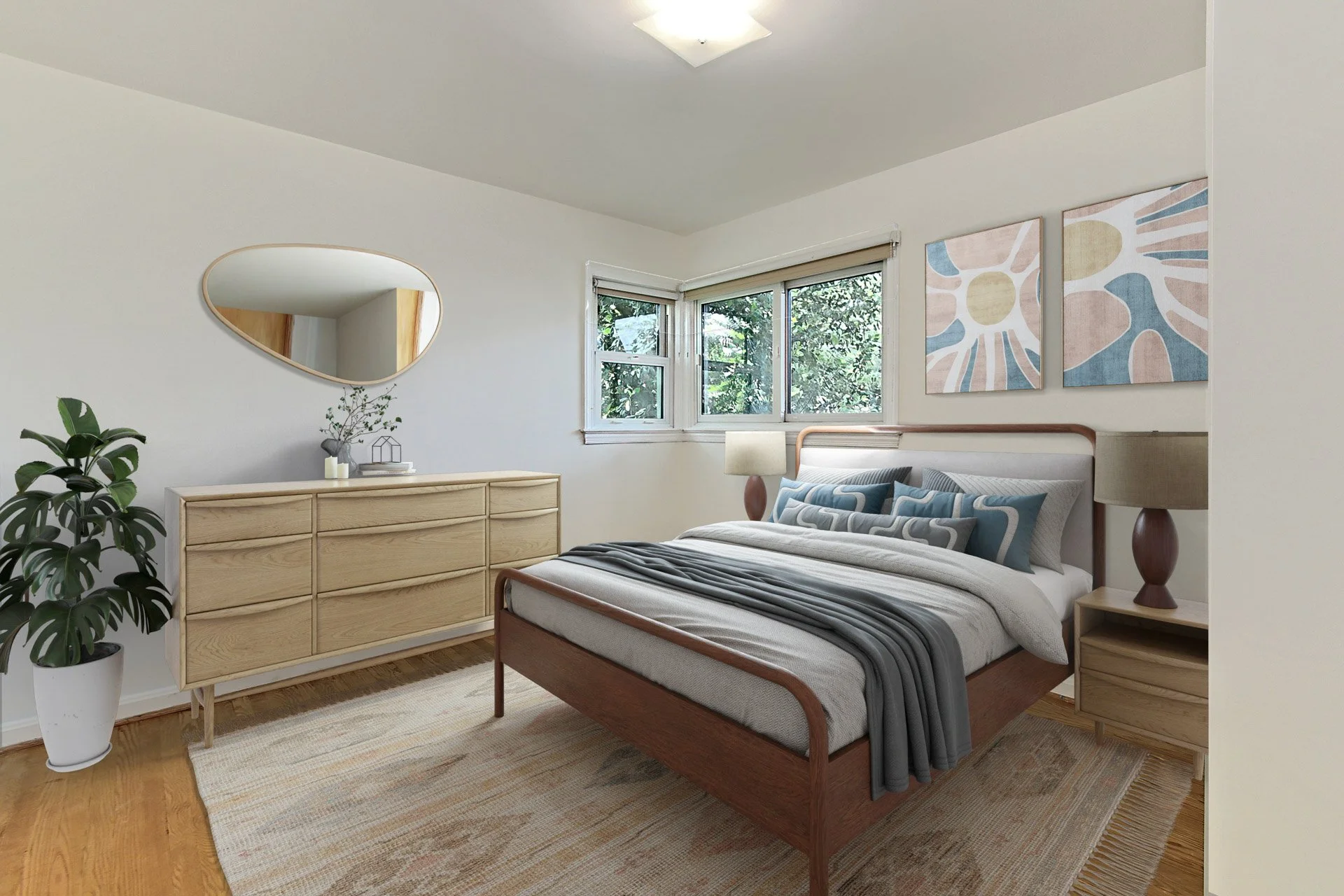A modern bedroom features a wooden bed with a beige and gray bedding set, a nightstand with a table lamp, a wooden dresser with a mirror, a large houseplant, and abstract wall art, with natural light coming through a window.