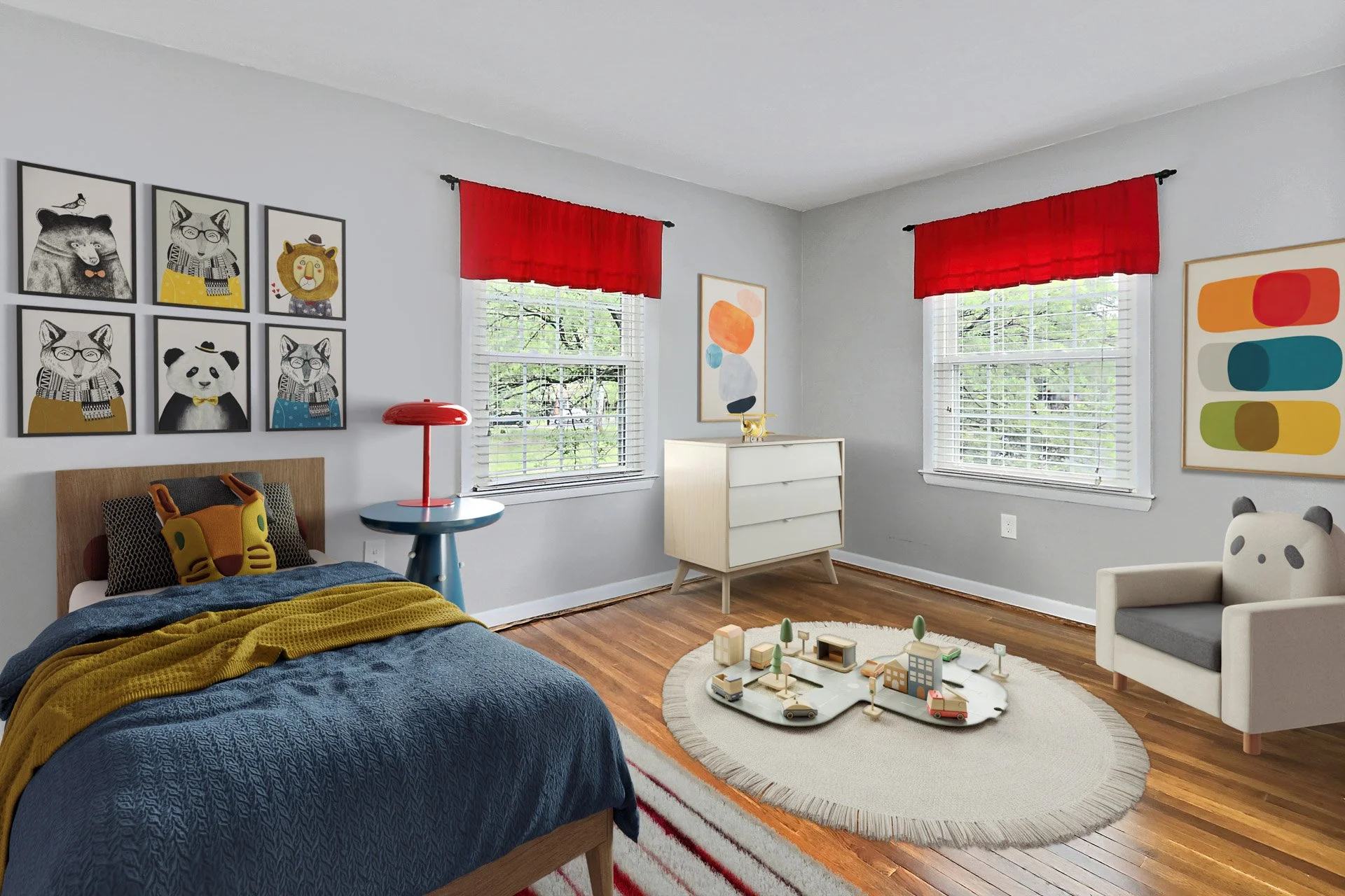 Decorated child's bedroom with a bed, colorful pillows, wall art, a dresser, and a chair, with windows and red curtains, on a wooden floor.