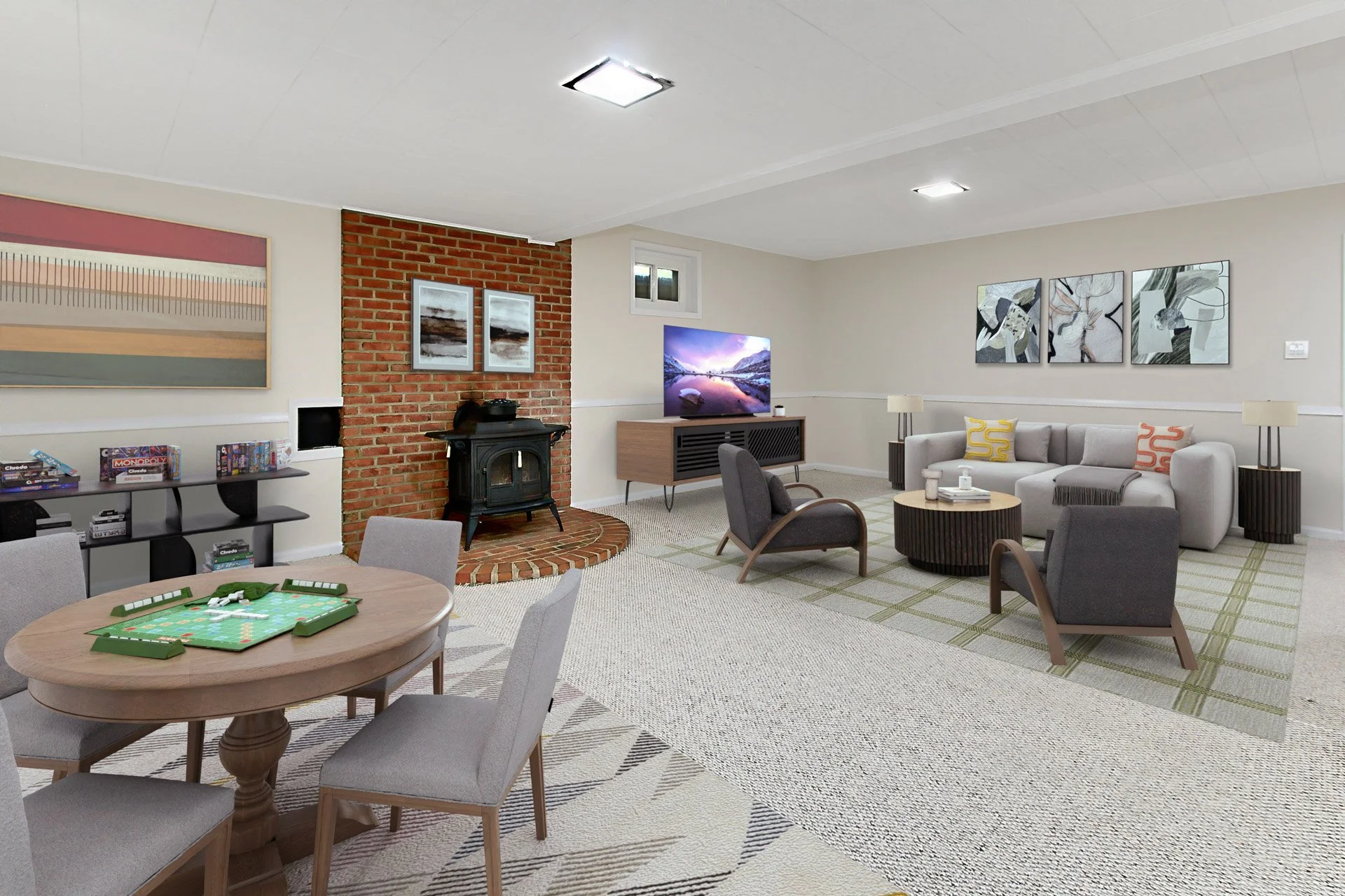 Living room with a brick chimney, fireplace, flat-screen TV, sofa, armchairs, abstract wall art, lamp, small window, and a bookshelf with board games.