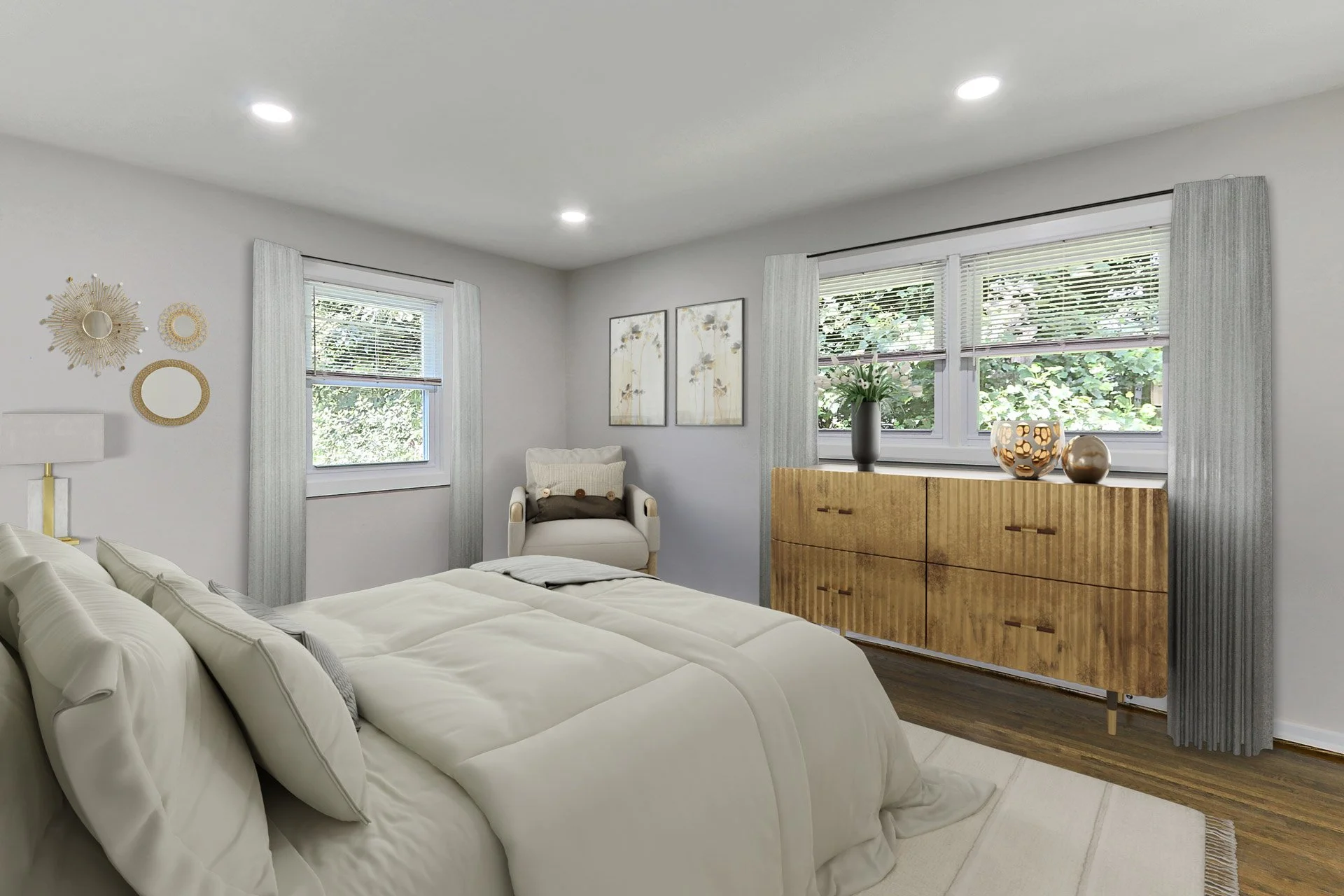 A cozy bedroom with a white bed, two windows with blinds and light curtains, decorative wall art, a wooden dresser with vases and flowers, and a white armchair with a throw pillow.