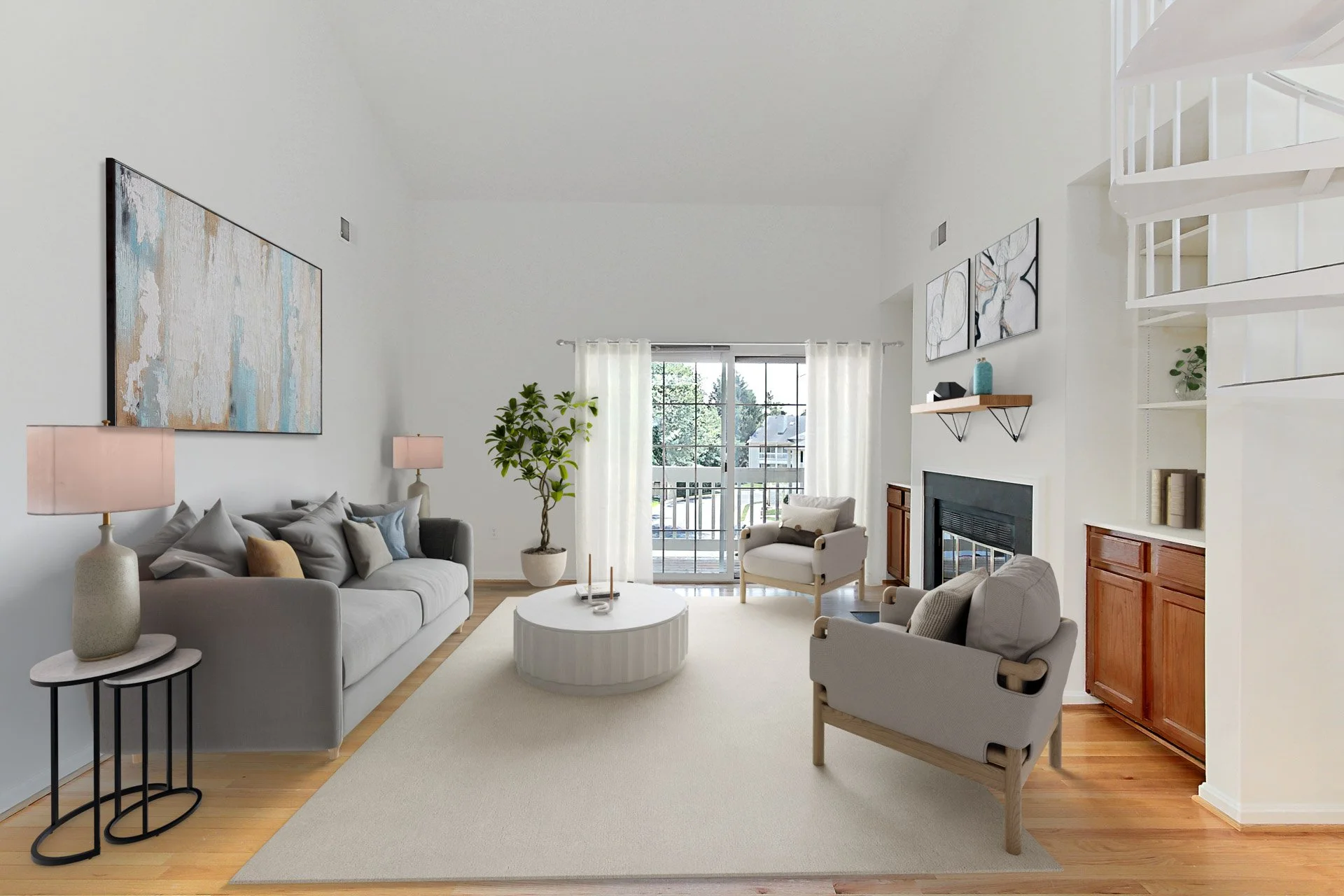 Bright living room with white walls, hardwood floor, gray sofa, white armchair, coffee table, fireplace, large window with white curtains, potted plant, wall art, and built-in shelves.