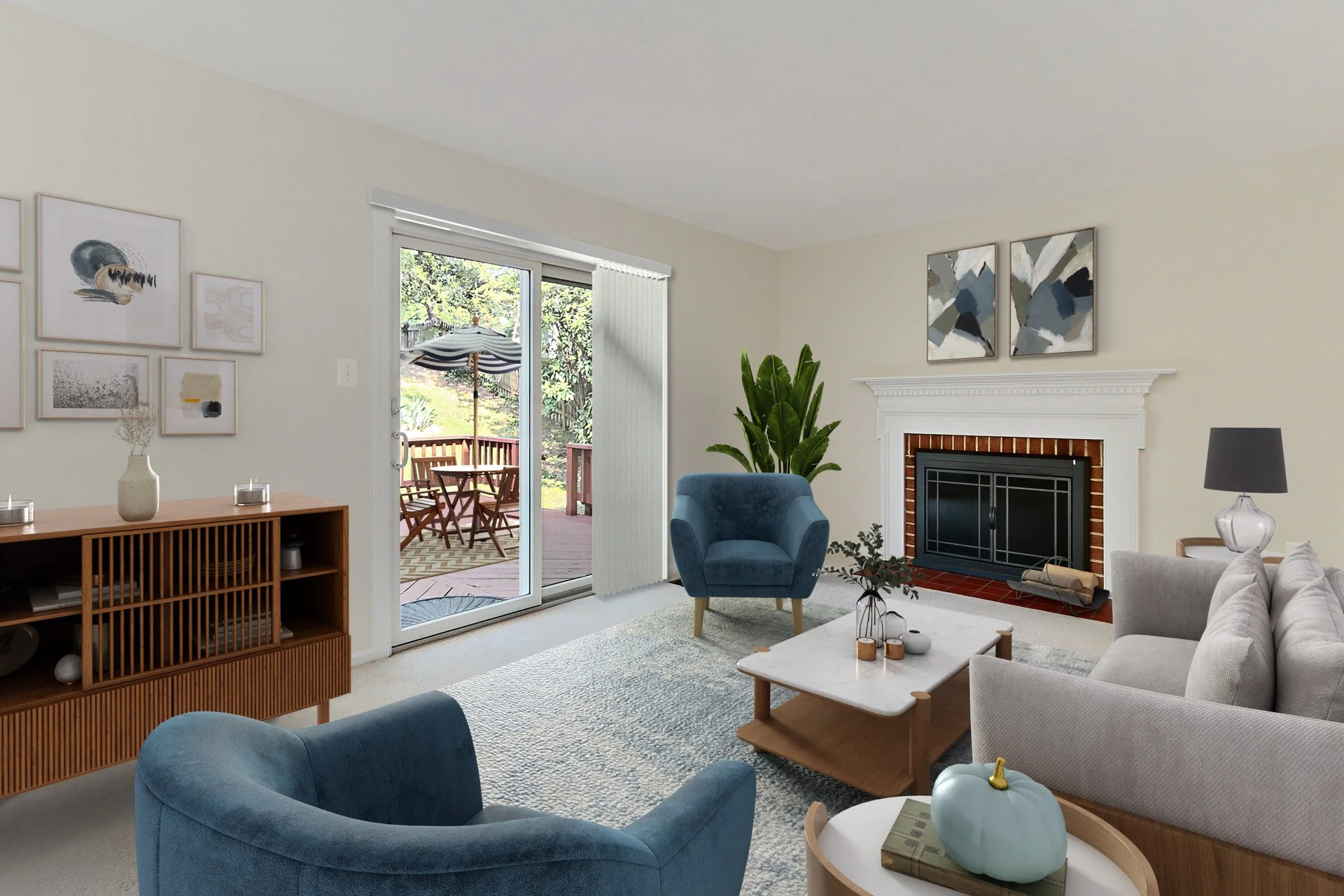 A cozy living room with a white fireplace, blue armchair, gray sofa, wooden coffee table, and decorative items, with sliding glass door leading to an outdoor patio with a table, chairs, and umbrella.
