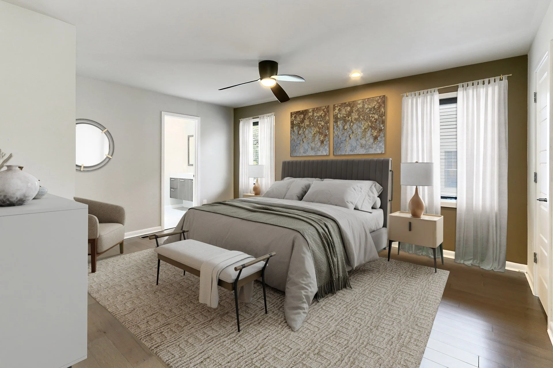 Modern bedroom with beige and white color scheme, featuring a bed with a gray upholstered headboard, white bedding, and artwork above the bed, with nightstand lamps, white curtains, and a ceiling fan.