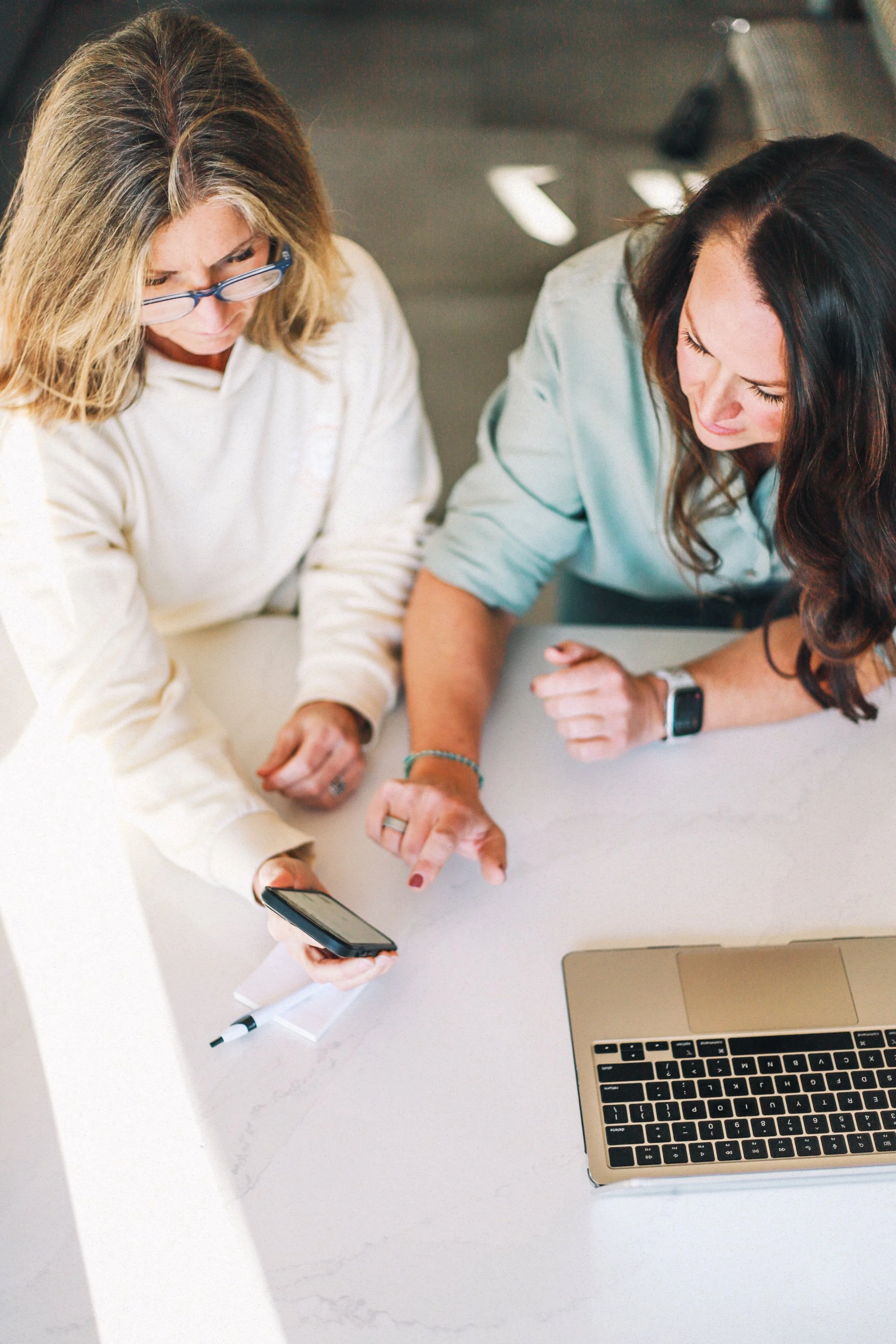 Person using a smartphone to view a digital calendar for the year 2024.