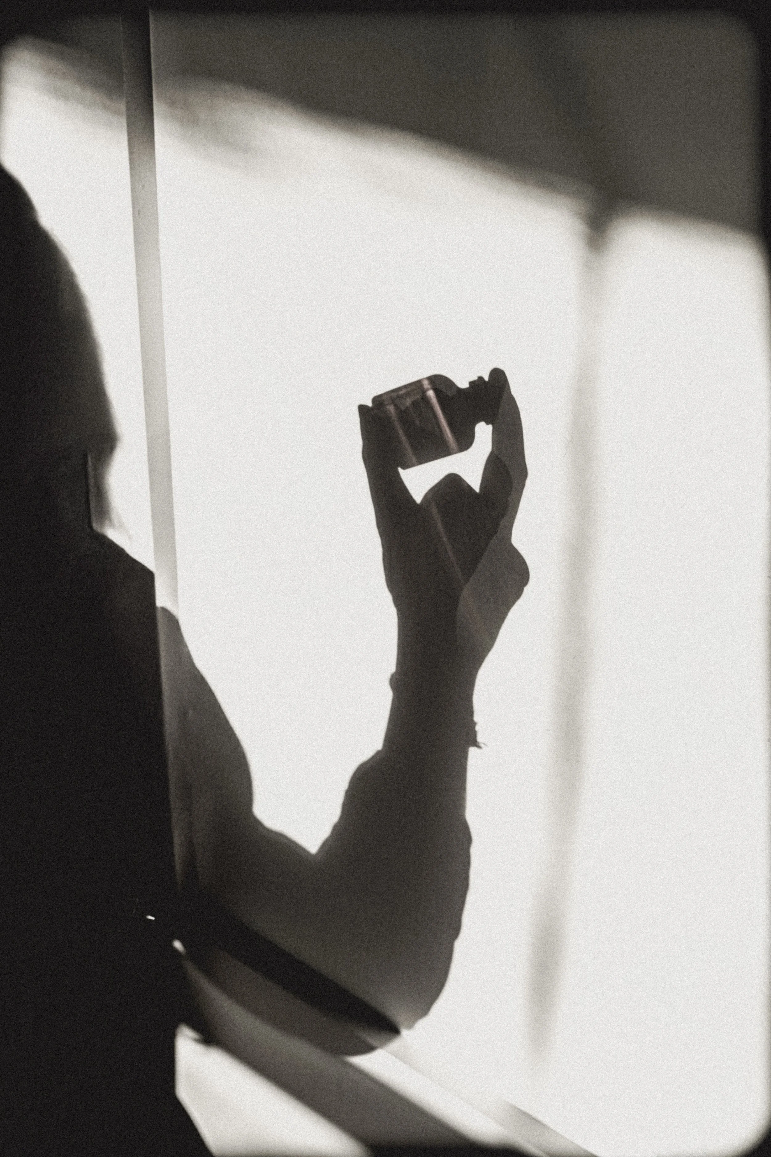 Person standing barefoot on a white digital bathroom scale on a tile floor, with a pink yoga mat visible on the right side.