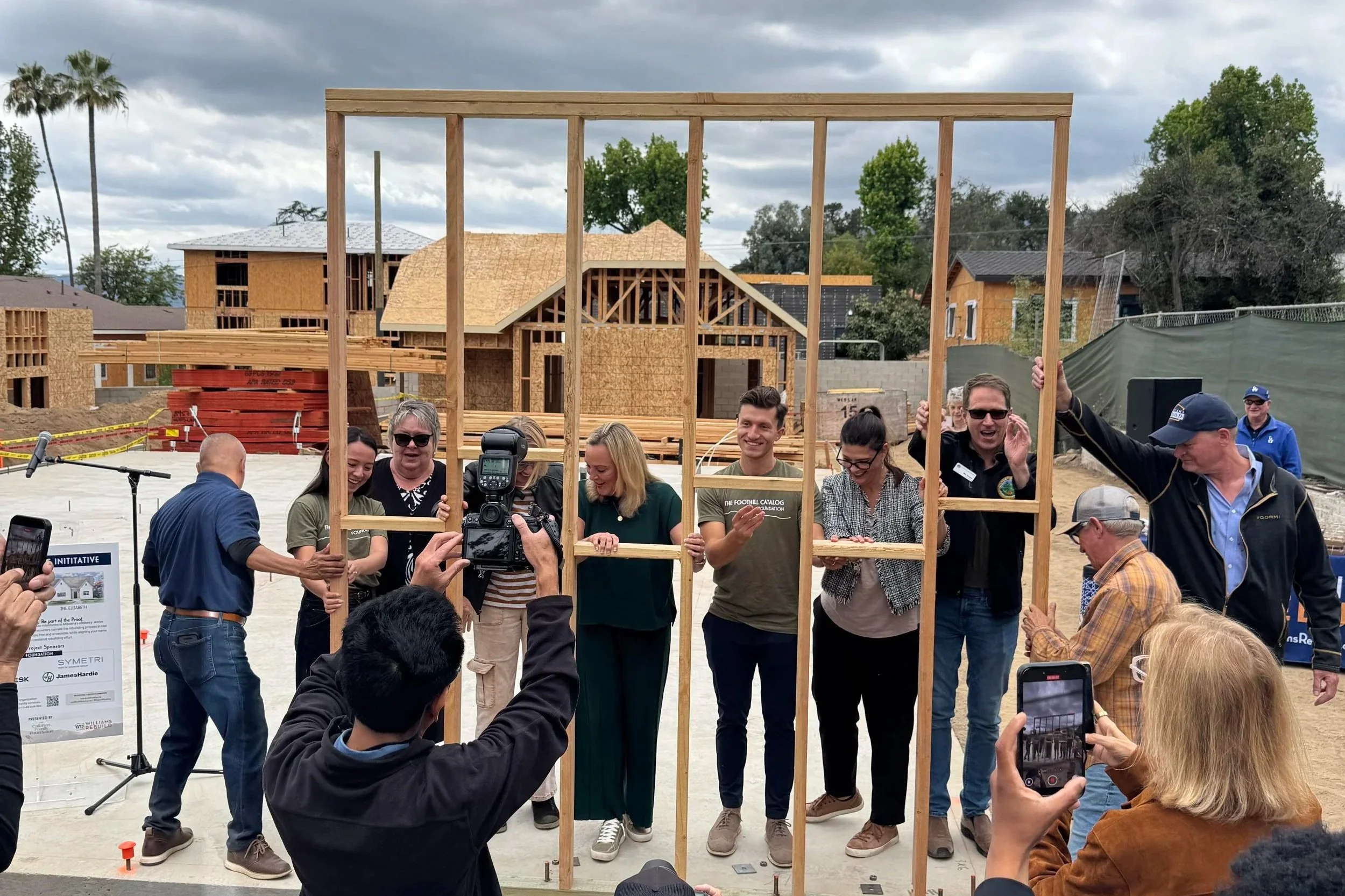 Leaders from the Foothill Catalog, as well as local organizations & goverment, join together in a wall raising at the site of the Tonia homes.