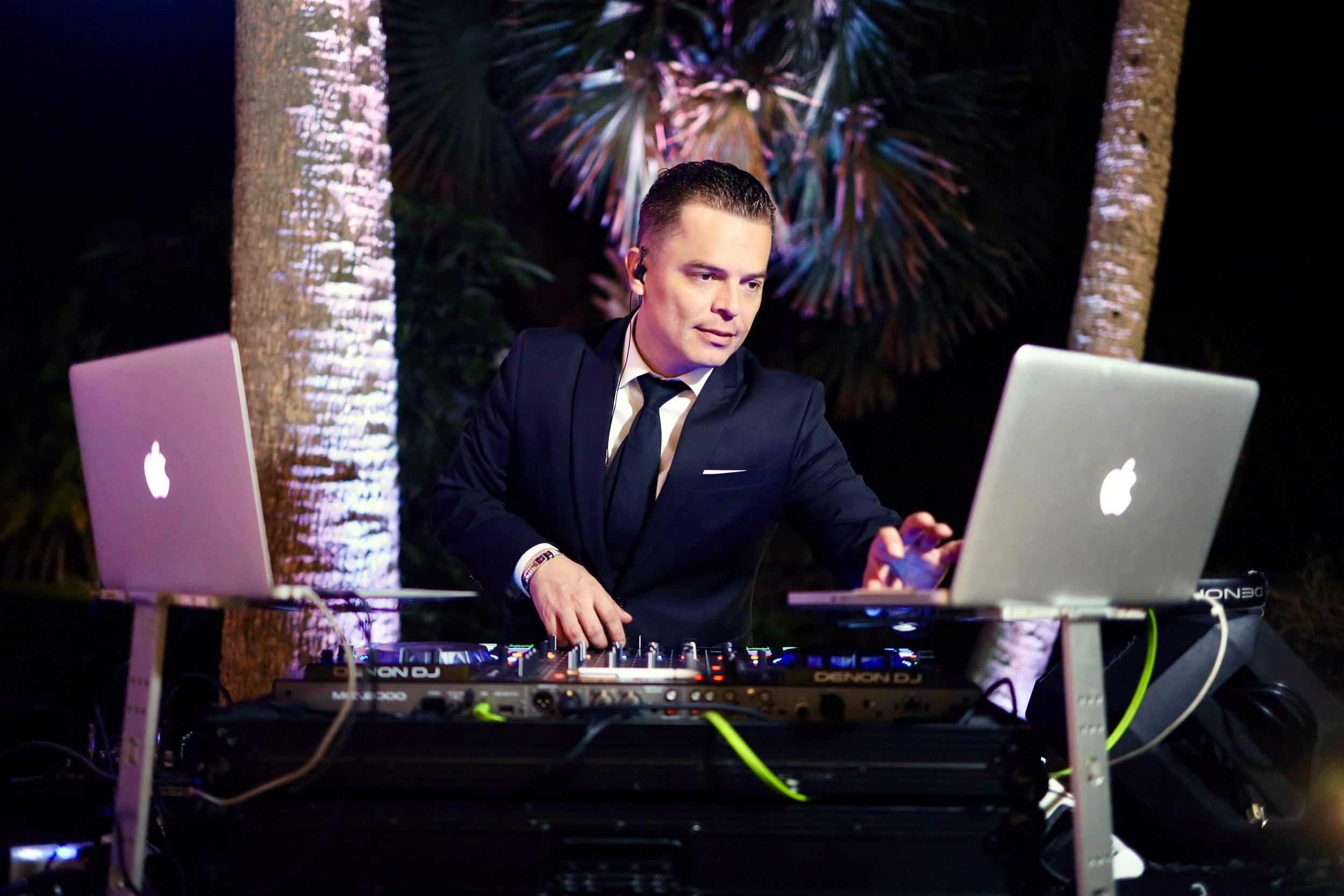 DJ hosting event with laptop and microphone