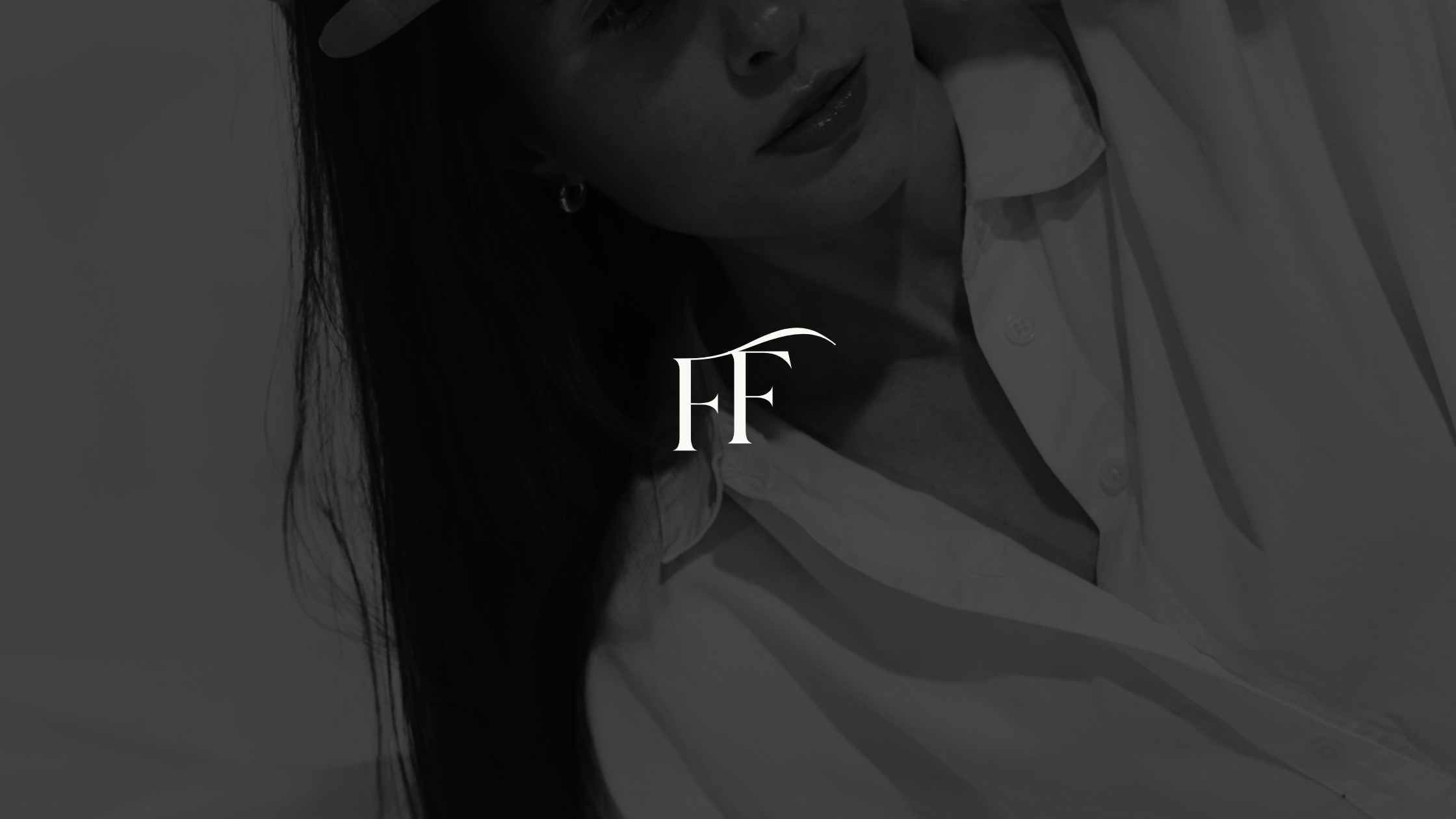 Close-up black and white photo of a woman with long dark hair, wearing a white shirt, smiling softly, with initials 'FF' overlaid in the center.