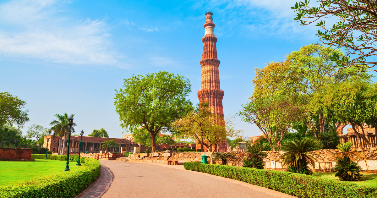 Qutab Minar viewed from a landscaped path within the archaeological complex in Mehrauli, South Delhi