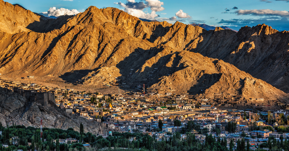 Leh town and surrounding mountains in golden evening light