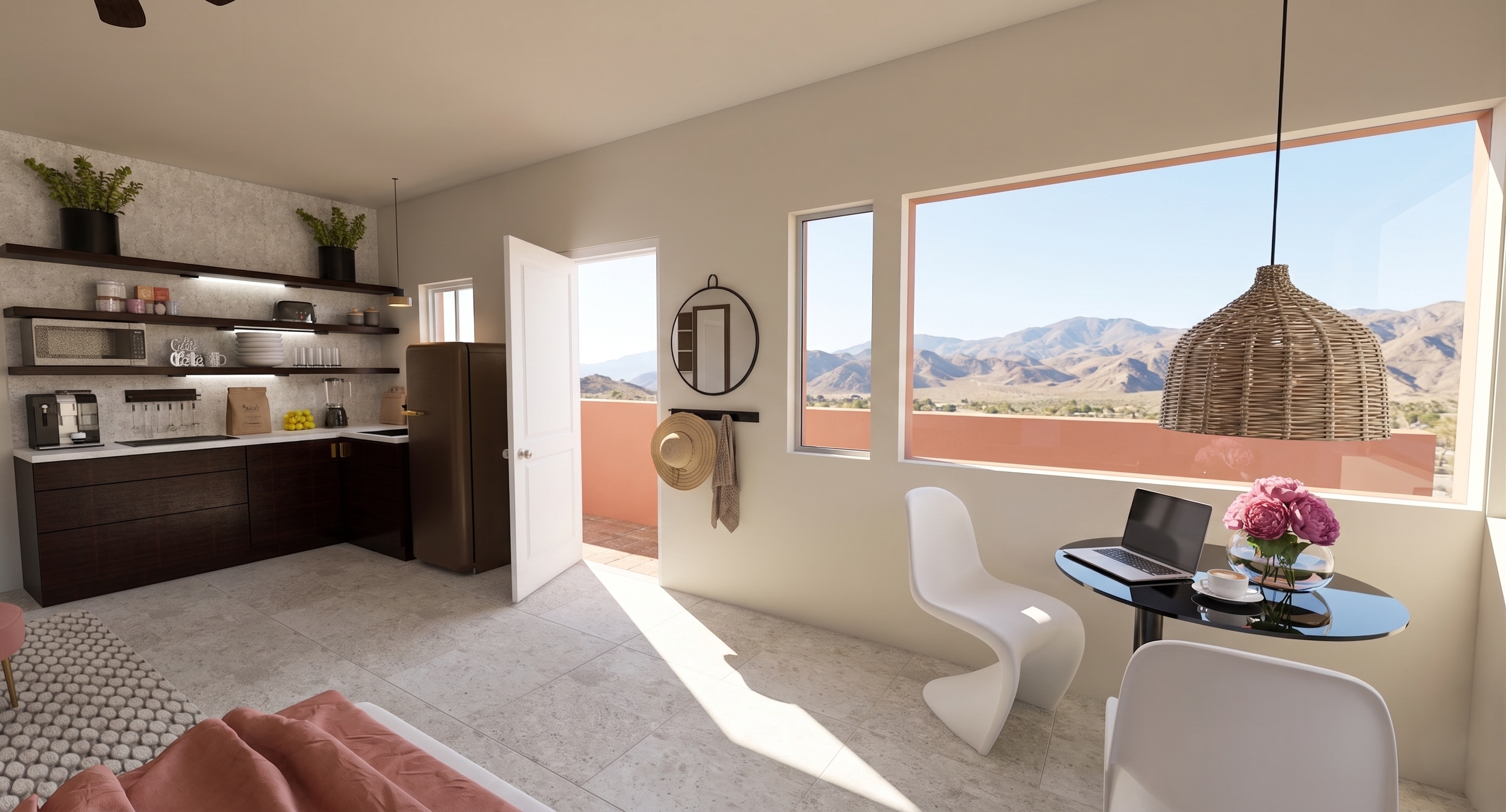 Modern kitchen and dining area with large windows showing mountain views, a white table with a laptop and pink flowers, and dark cabinetry with open shelves holding kitchen essentials.