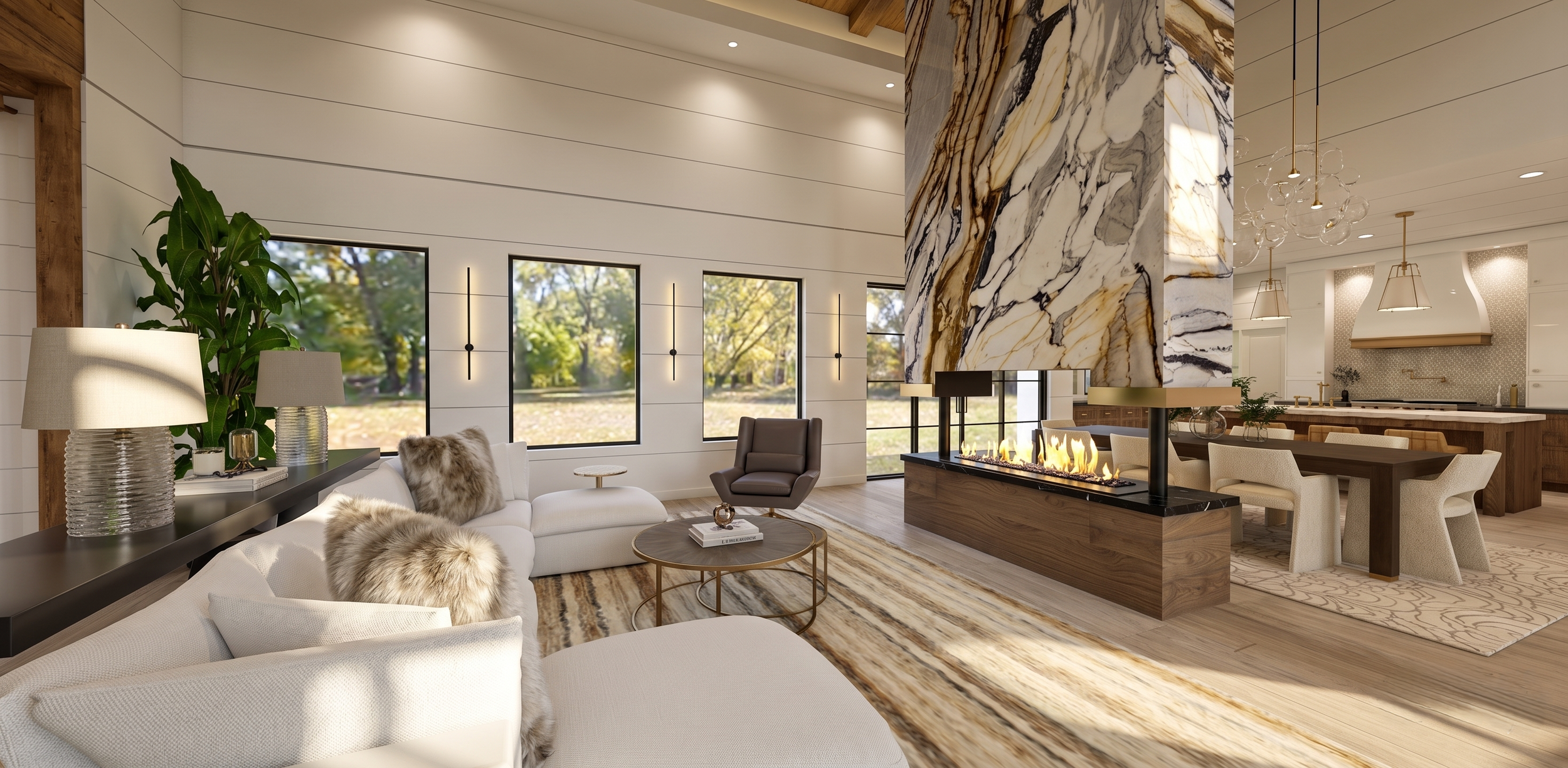 A modern living room with large windows, a white sofa with fur pillows, a glass coffee table, a dark armchair, and a fireplace with a marble and wood chimney. The space is decorated with lamps, plants, and a rug, and opens to a kitchen with a dining 