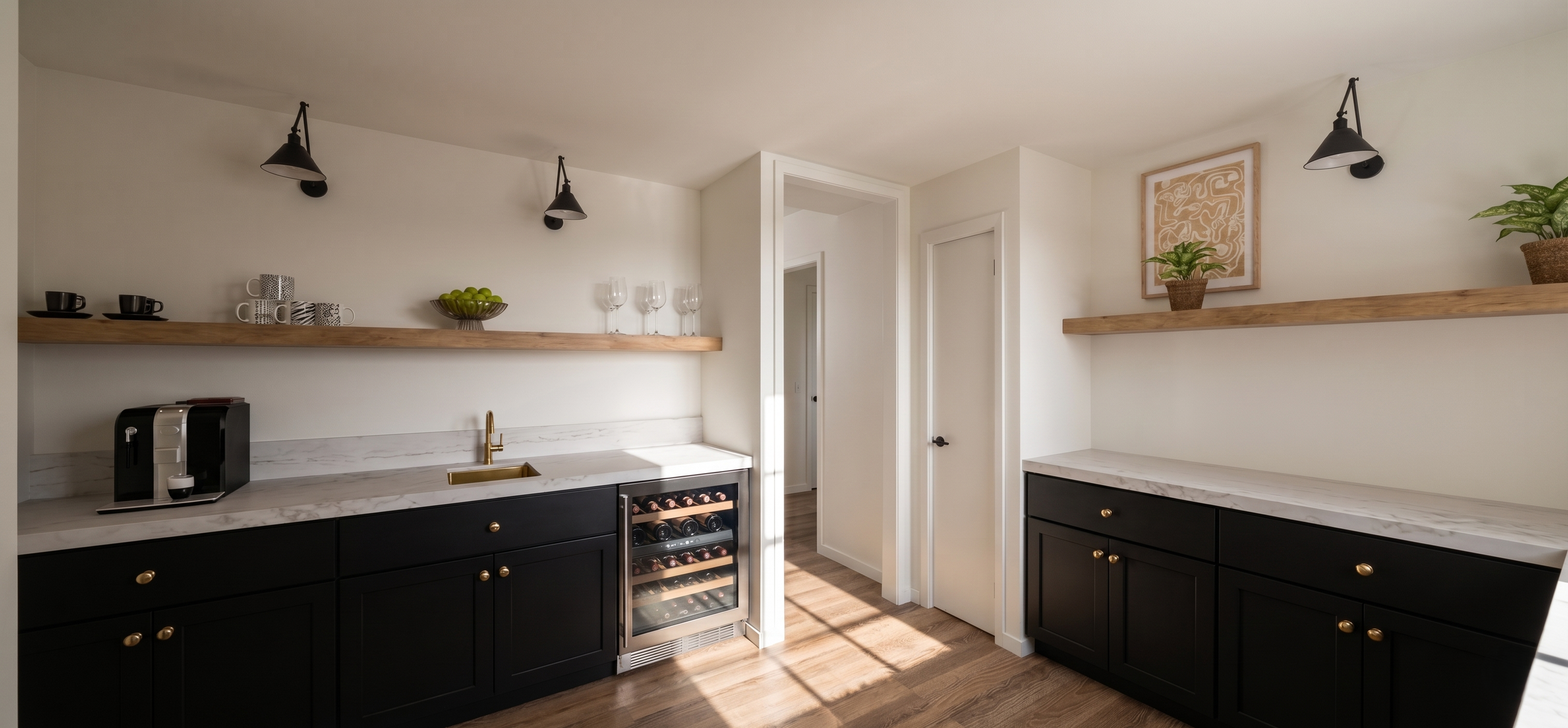Modern kitchen with black cabinets, white marble countertops, a small wine cooler, and wooden shelves decorated with cups, glasses, a bowl of green apples, and potted plants.