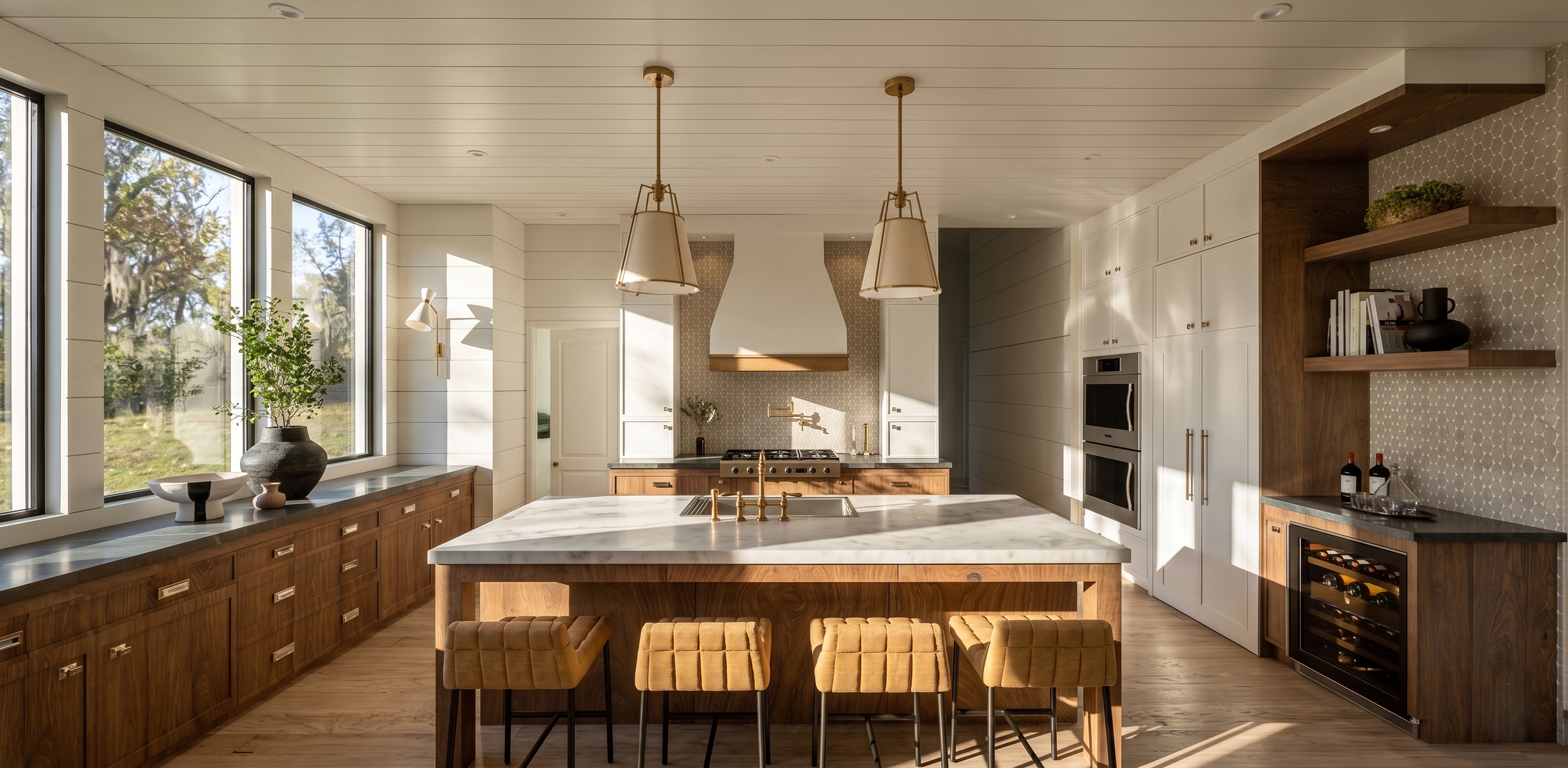 Modern kitchen with large windows, wooden cabinetry, a marble island with gold fixtures, and built-in appliances.