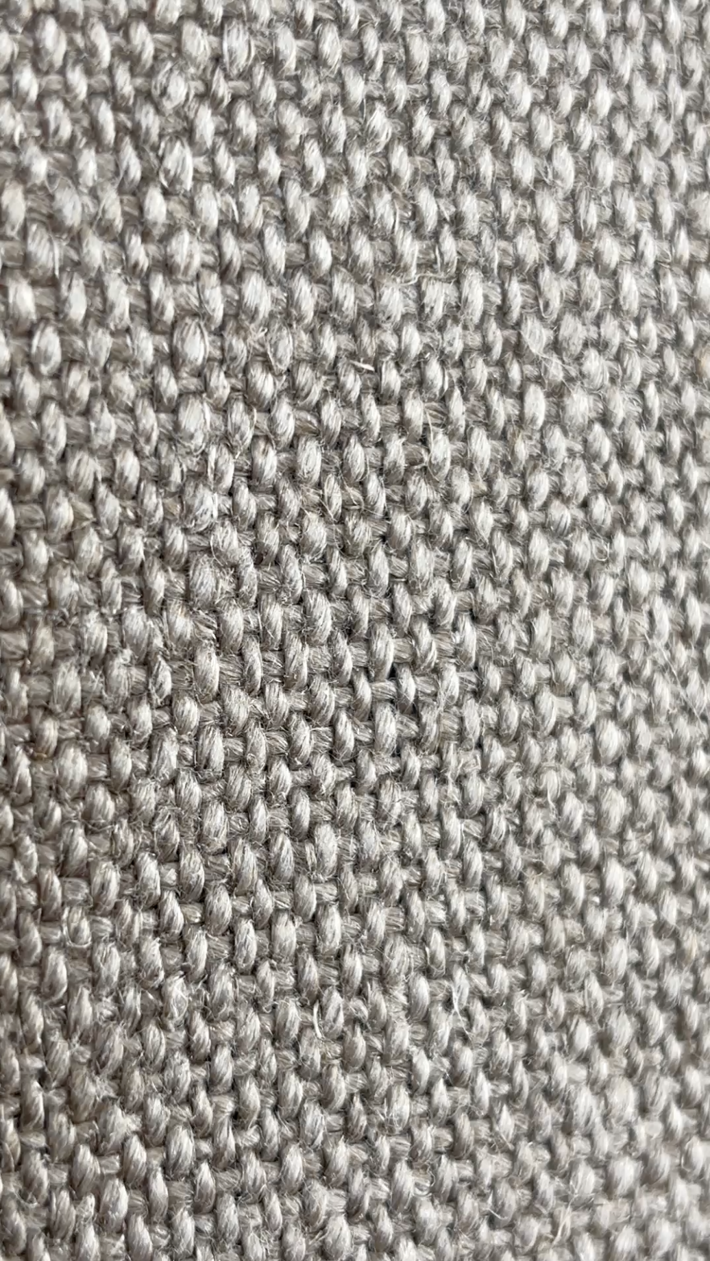 Close-up of a heavy, textured, natural linen fabric.