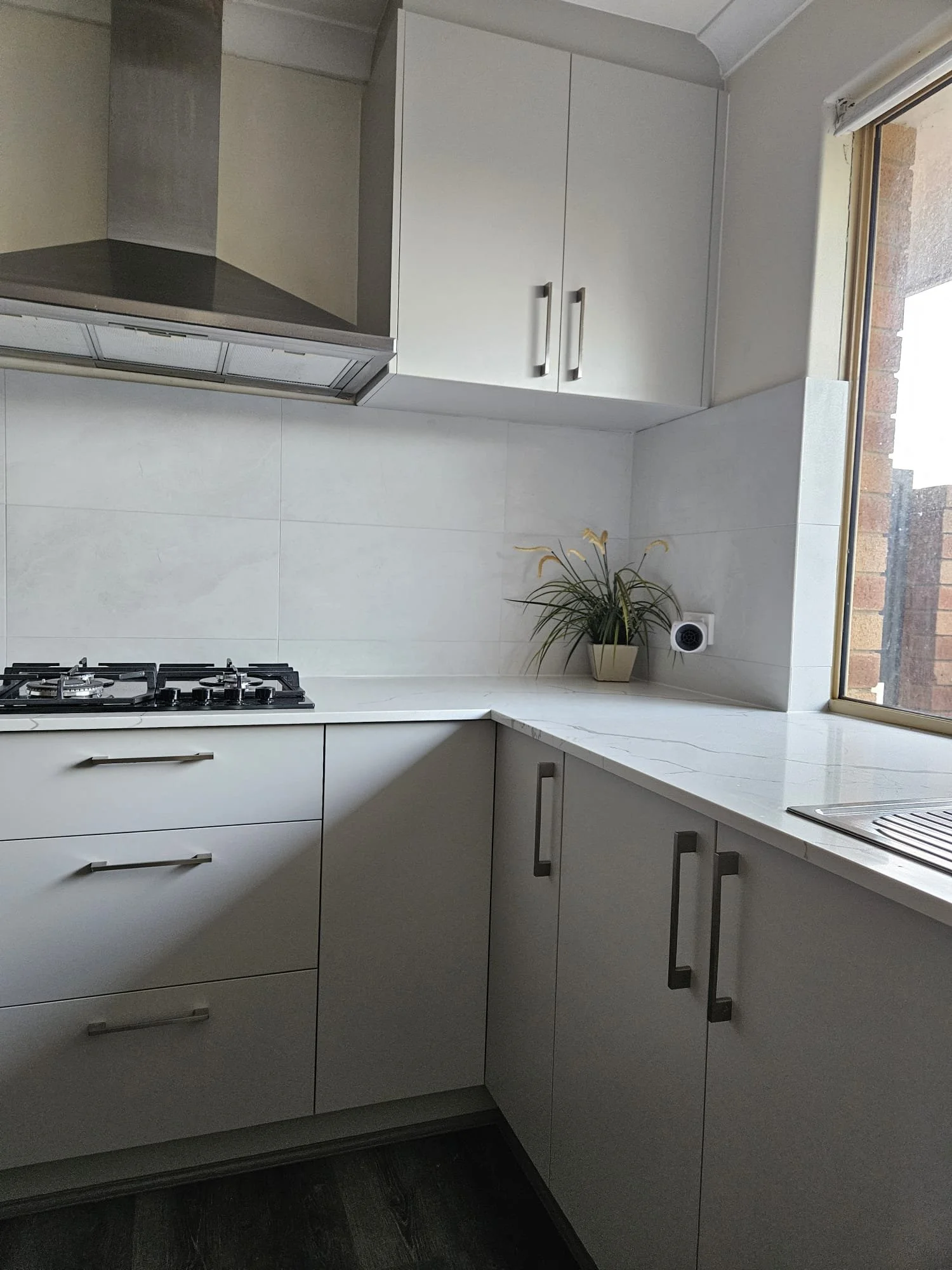 Modern kitchen renovation in Perth with timber cabinetry and stone benchtop by Ridge Renovations