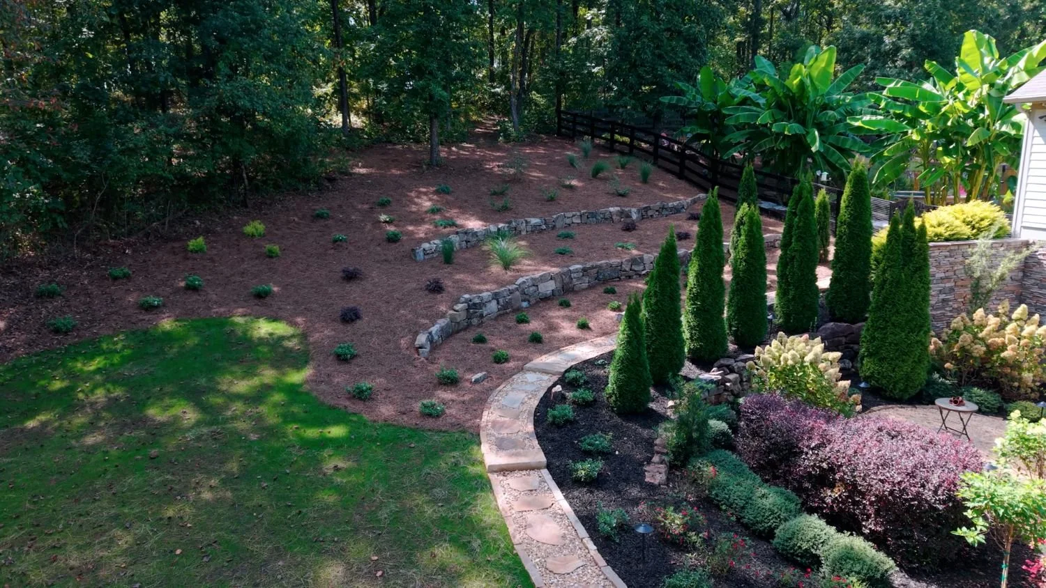 Stone patio and garden layout designed for outdoor gatherings in East Cobb, GA