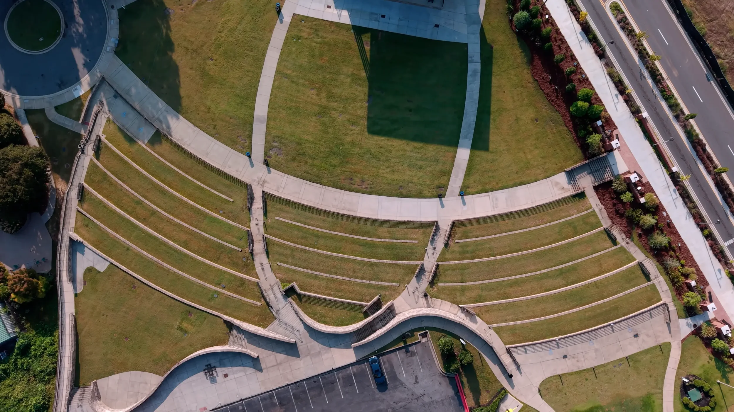 Curved pedestrian walkways and lawn care in a Downtown Woodstock, GA public space