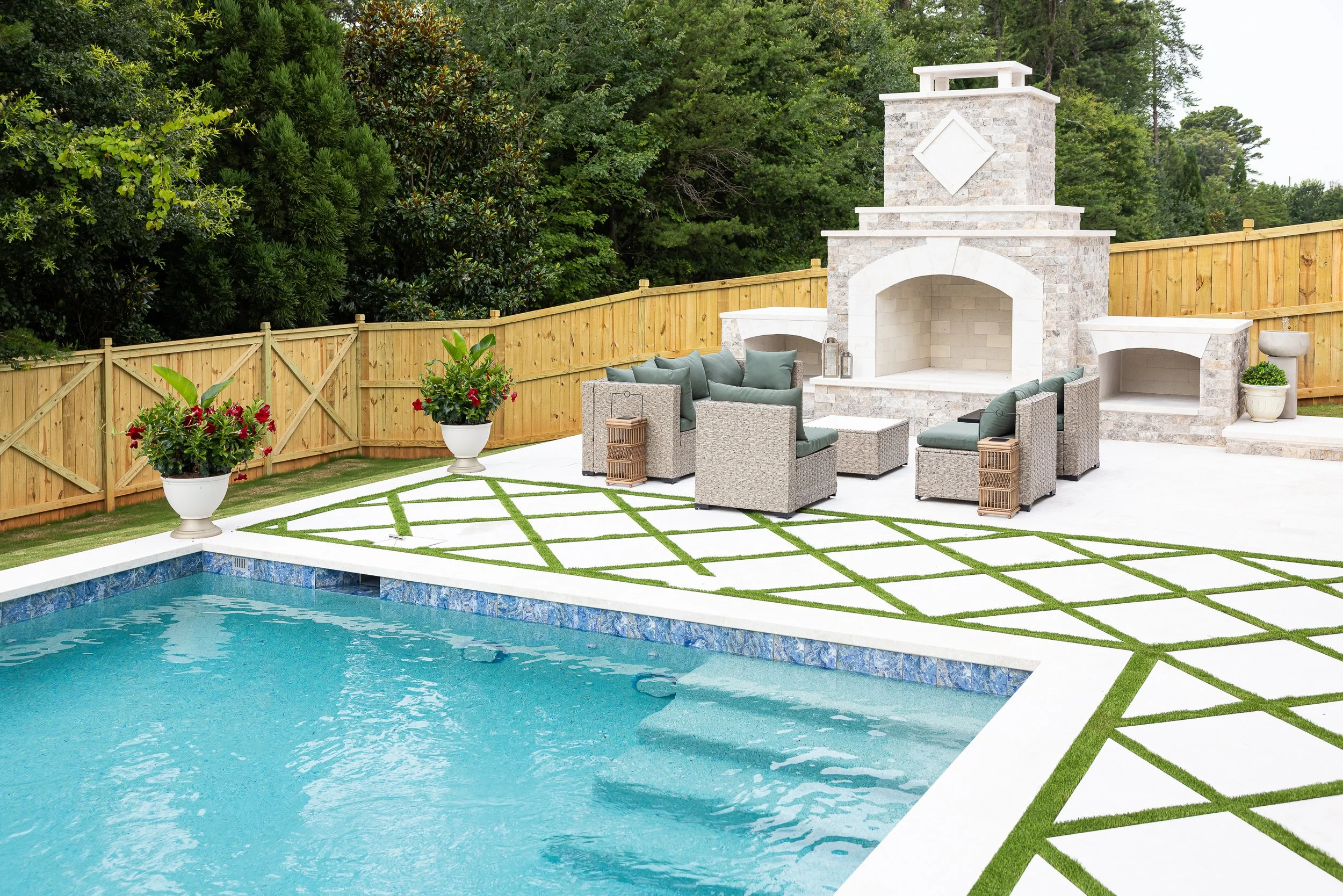 Pool patio with artificial turf between pavers
