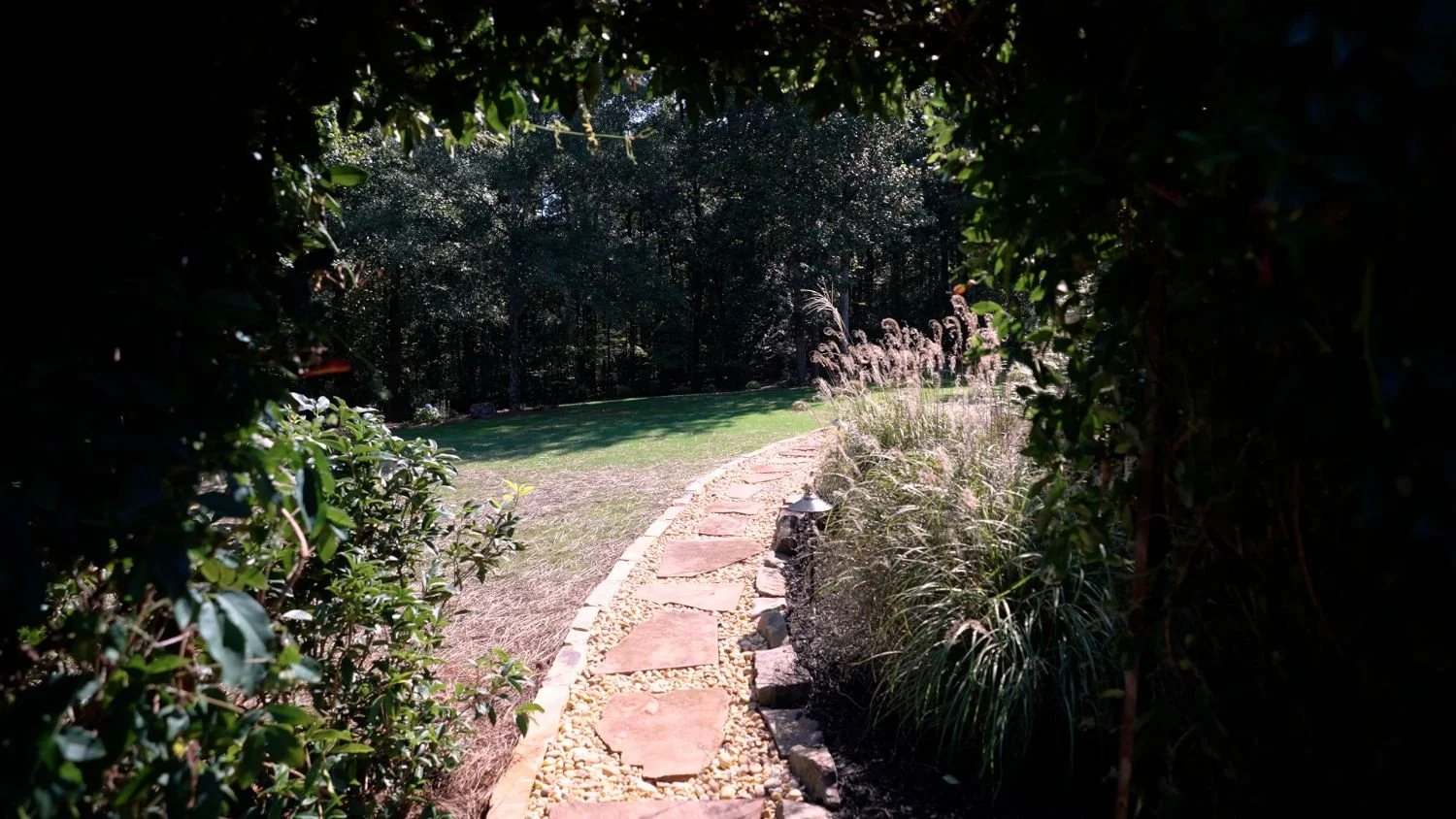 Curved garden pathway with retaining wall in a custom East Cobb, GA landscape