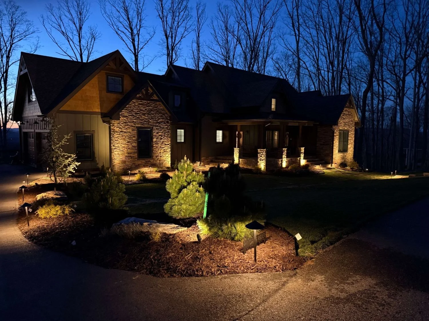 Elegant outdoor lighting illuminating front yard in Roswell, GA