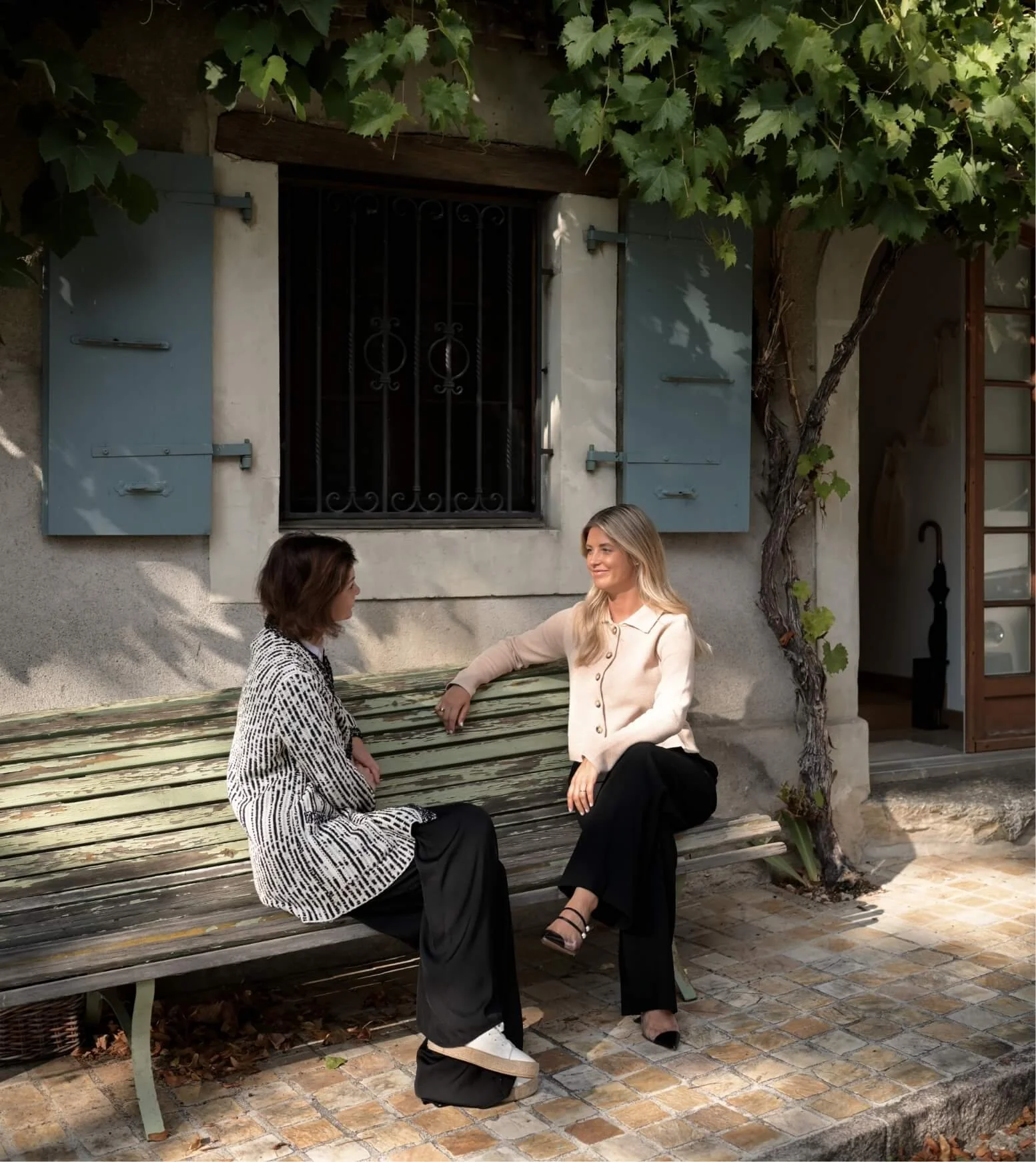 Ashley Allen, therapist and client talking outdoors, representing a collaborative holistic therapy approach in Switzerland.