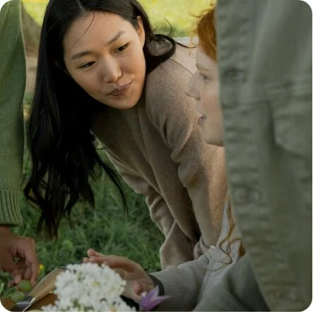Women having a supportive conversation outdoors, representing connection during anxiety therapy.