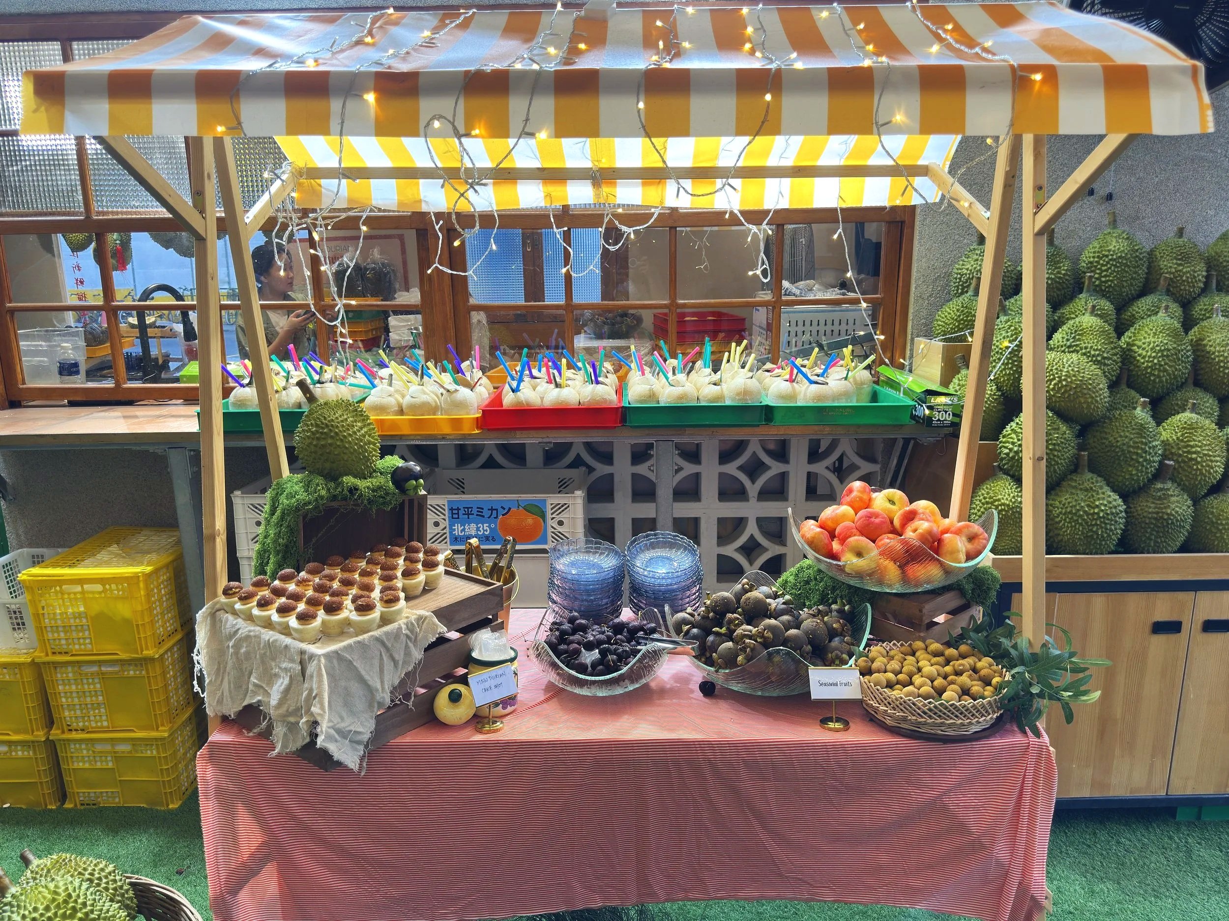 the seasonal fruits like mangosteen, longan, grapes and fresh coconuts are served during private durian party event at Ms Durian