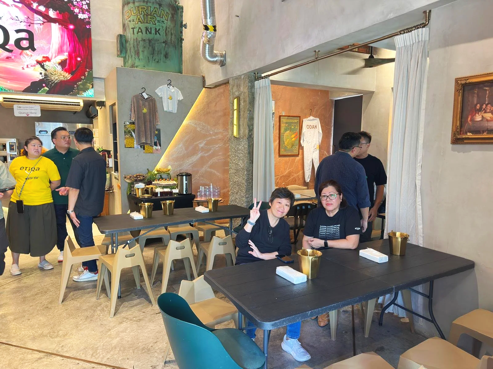 the indoor cafe area of Ms Durian where guests are hanging out and mingling with others comfortably