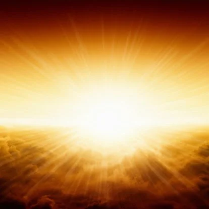 Image of the sun with its rays on a cloud backdrop at sunset