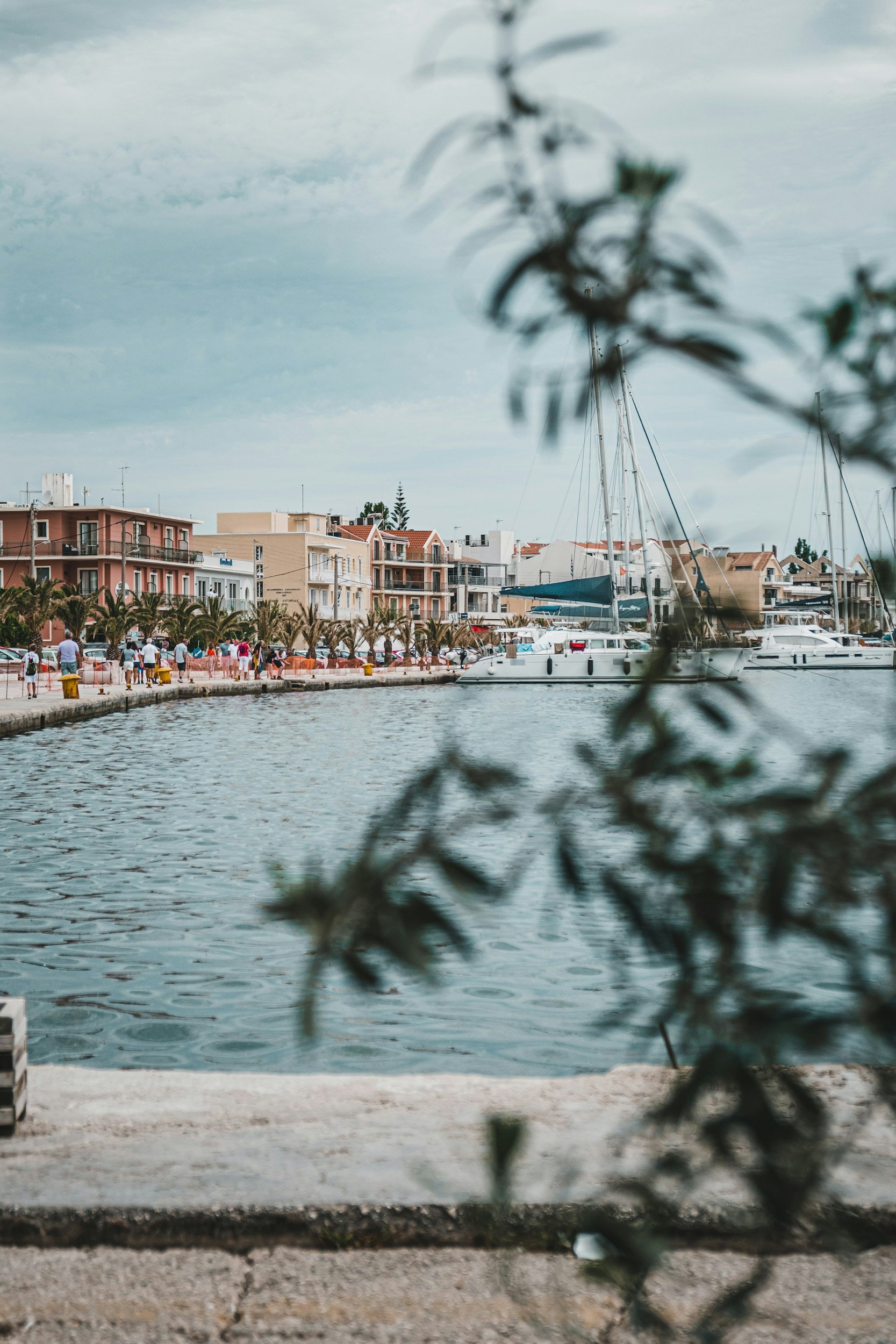 Argostoli port in kefalonia greece with people walking and boats docked