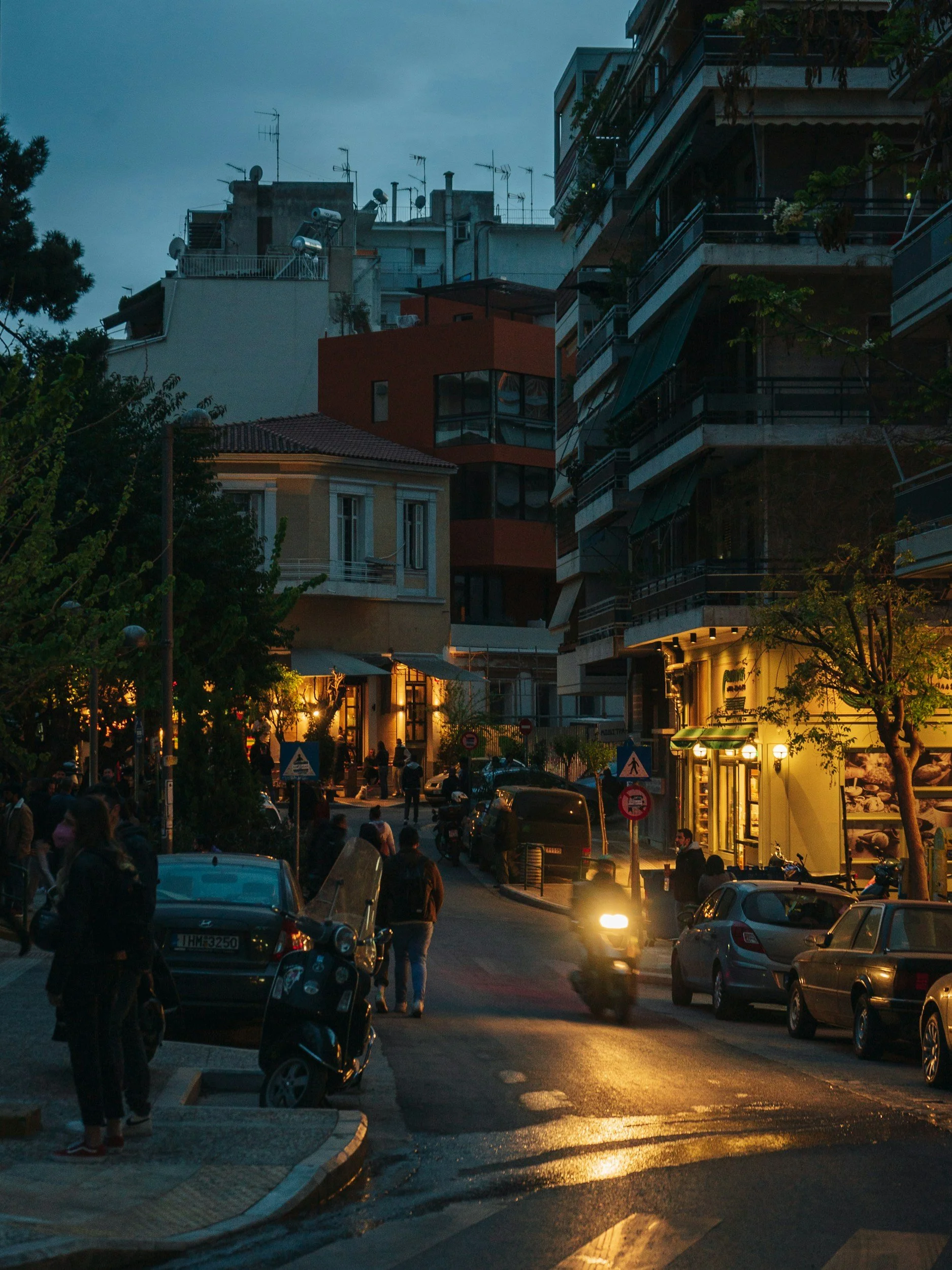 a street in Koukaki, Athens at night with bars and restaurants