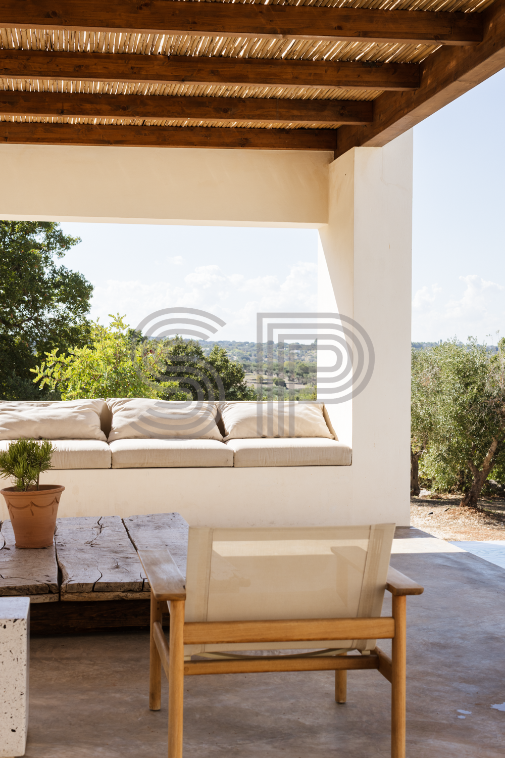 Contemporary villa film location in Puglia with covered outdoor terrace, bamboo roof, exposed timber beams and countryside views