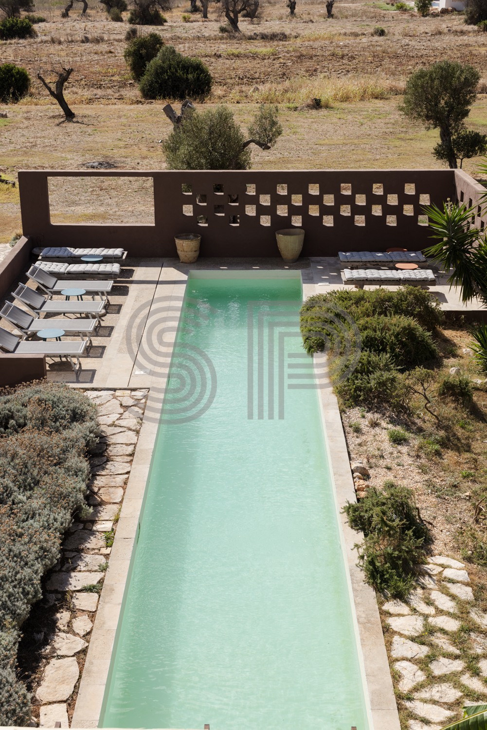 Contemporary villa in Puglia with long narrow swimming pool, landscaped Mediterranean gardens and open countryside views