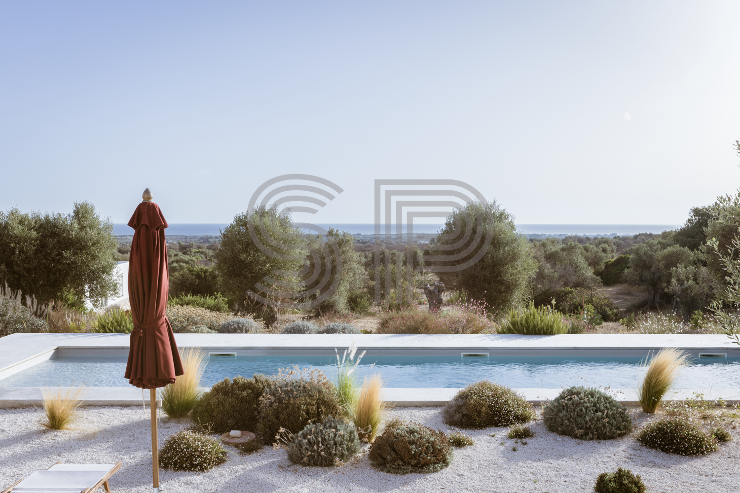 Elevated contemporary white villa shoot location in Puglia with swimming pool, Mediterranean gardens and panoramic sea views