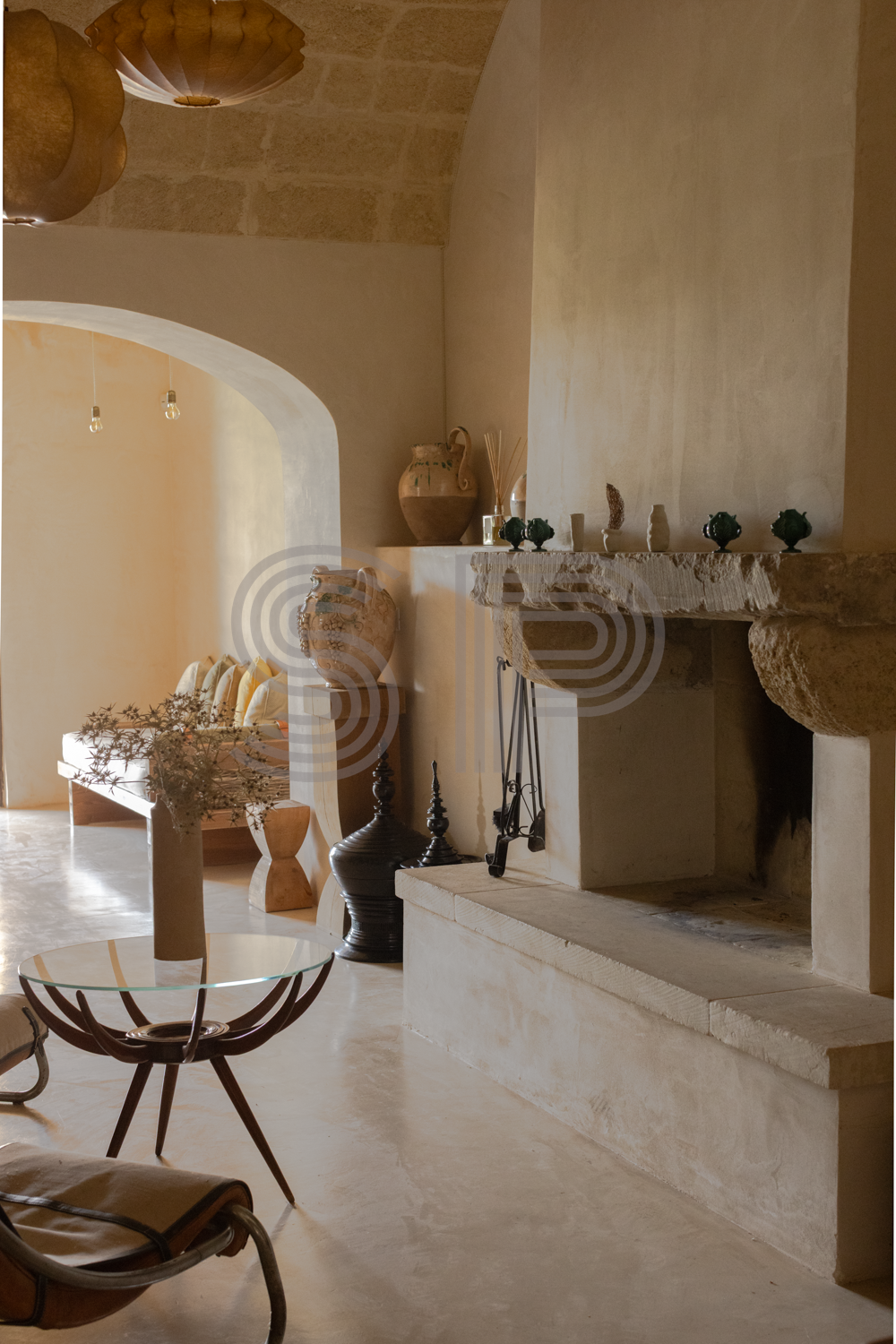 Puglia interior shoot location with vaulted stone ceiling, fireplace and neutral styling