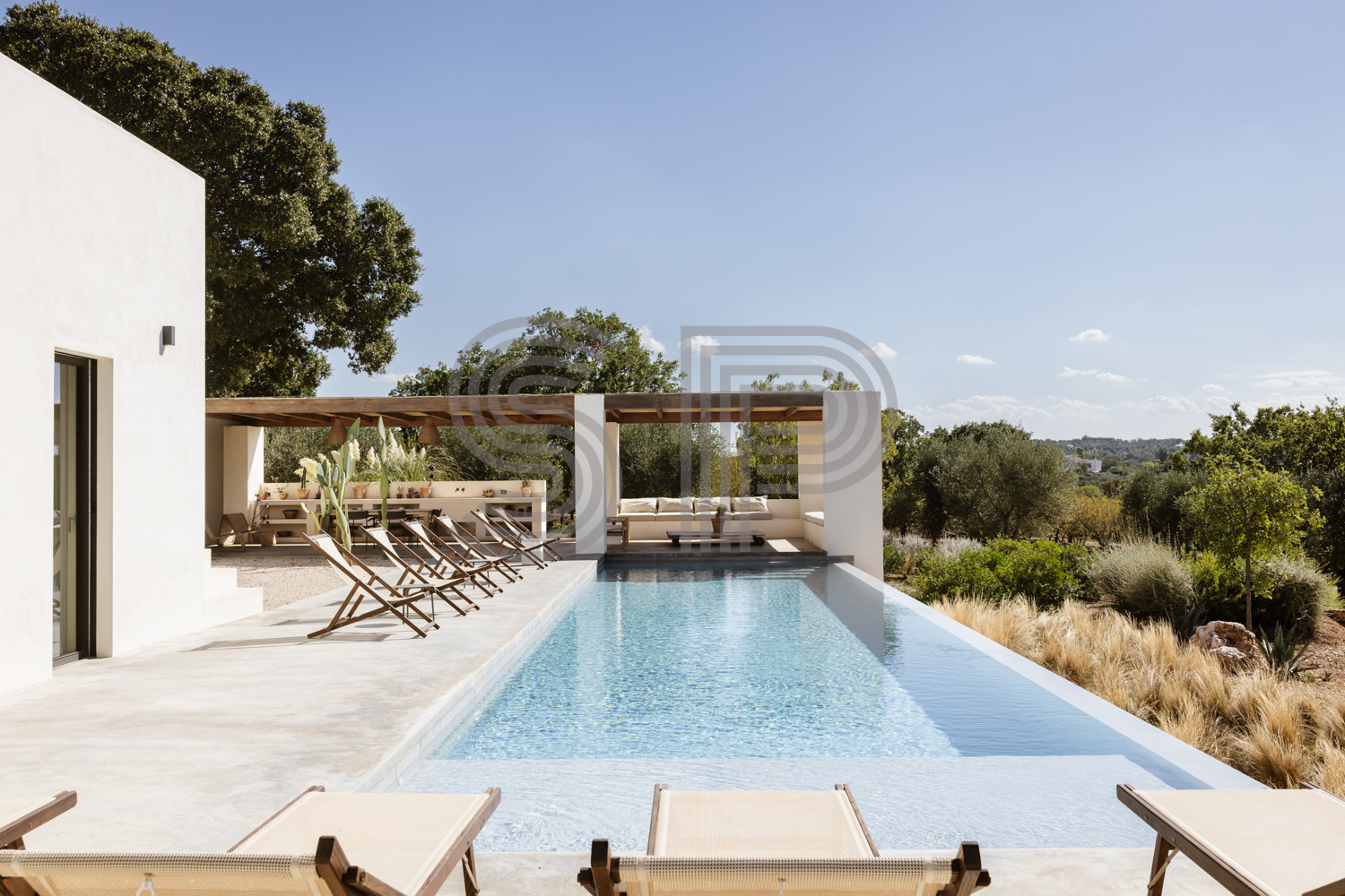 Contemporary white villa shoot location in Puglia with infinity swimming pool, spacious stone terrace and panoramic countryside views