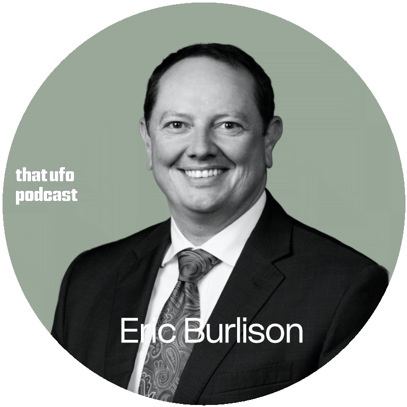 A black-and-white headshot of Eric Burlison, dressed in a suit and tie, smiling, with a green background. Text on the image reads 'thatufo podcast' and 'Eric Burlison.'