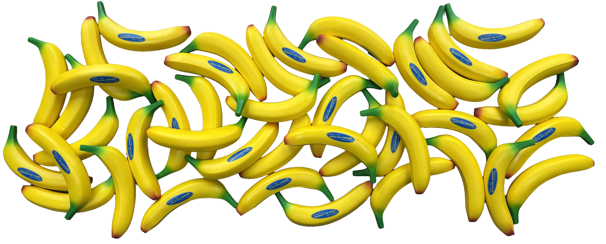 A pile of realistic-looking toy bananas with green stems and blue labels that say "BANANA FOR SCALE."