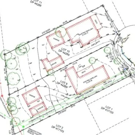 A site plan showing property boundaries, existing and proposed structures, trees, and utility lines for a residential development project.