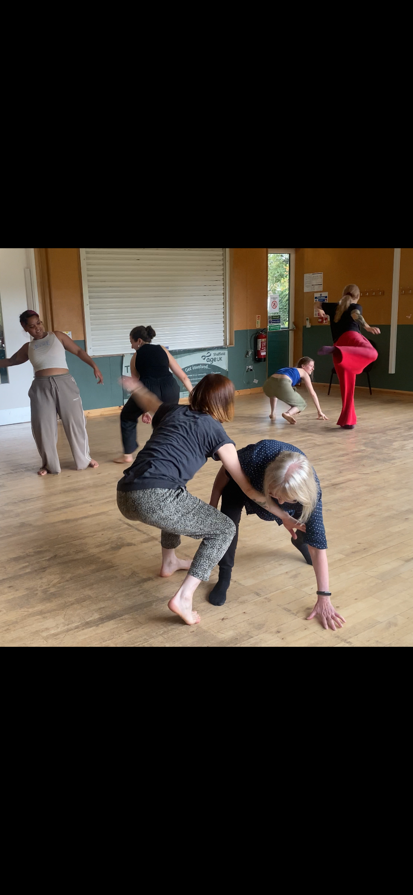 Six people dancing in pairs, standing and on the floor