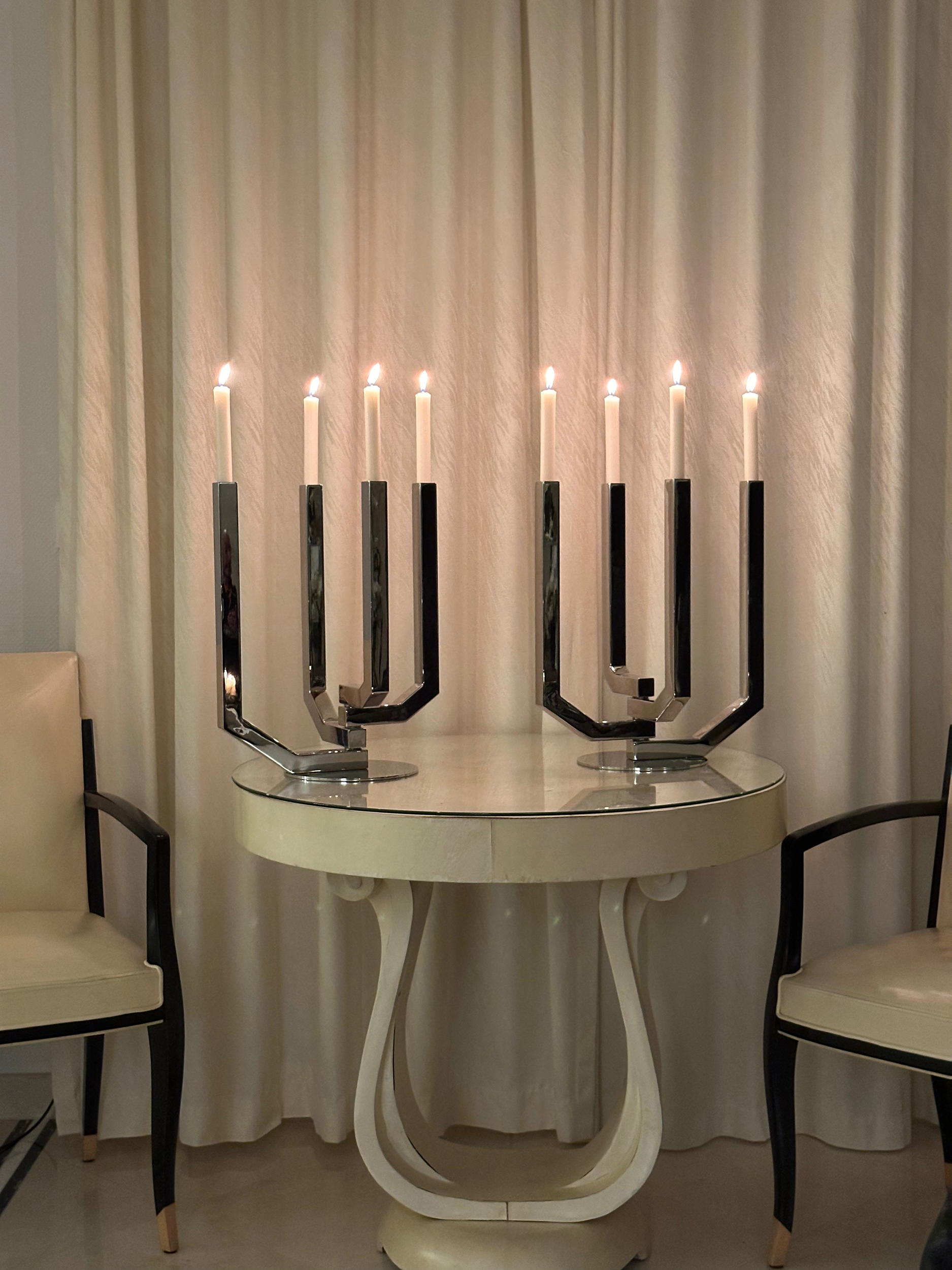 The candelabra highlighted in the image belongs to the Arborescence Collection by Christofle.Designed by: The prominent French designer Ora-Ïto (Ito Morabito).Designed in: The collection was created in 2010.Crafted from sleek stainless steel, this fu