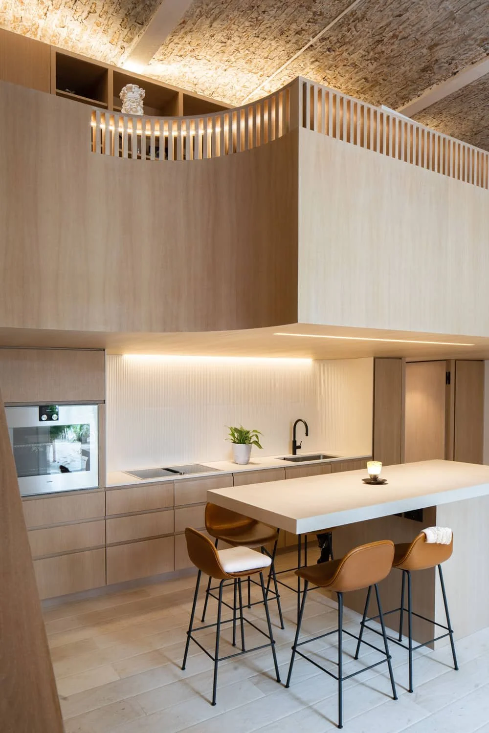 Double-height living area with expansive windows, minimalist furnishings, and a striking ceiling design, emphasizing verticality and openness