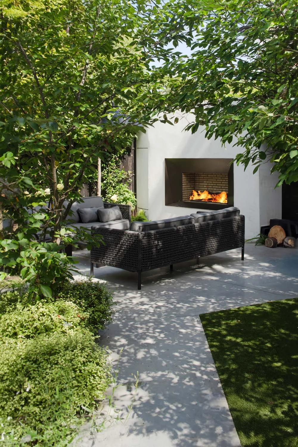 Tranquil garden seating area with modern furniture, surrounded by greenery and contemporary design features