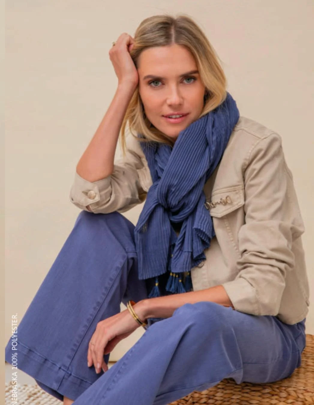 Elora clothing - lady in cream jacket, purple scarf and trousers
