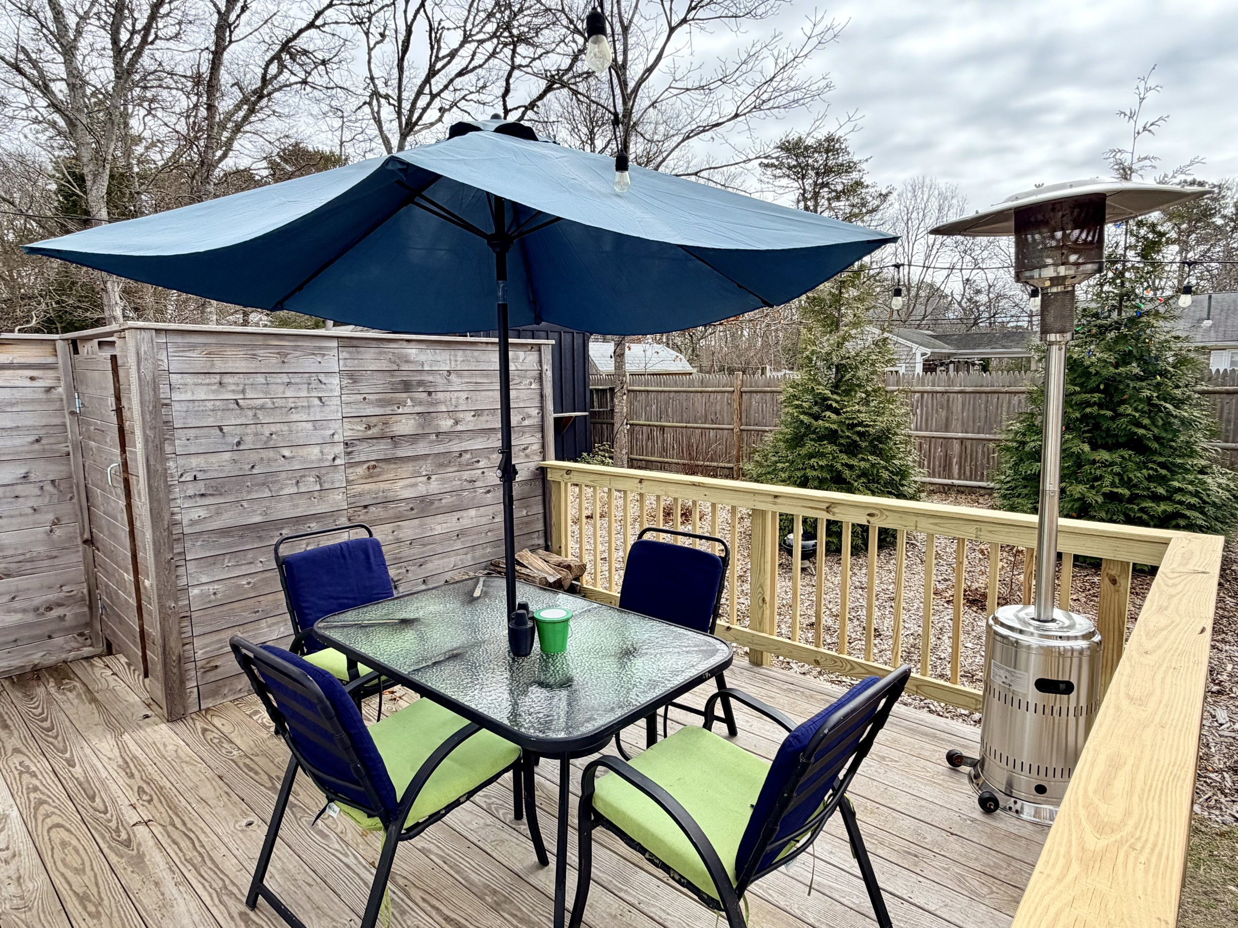 Cape Cod Vacation Rental Management | Tuxfin Hospitality Property - Harwich Dog Friendly Home - Deck with Dining Table and Umbrella