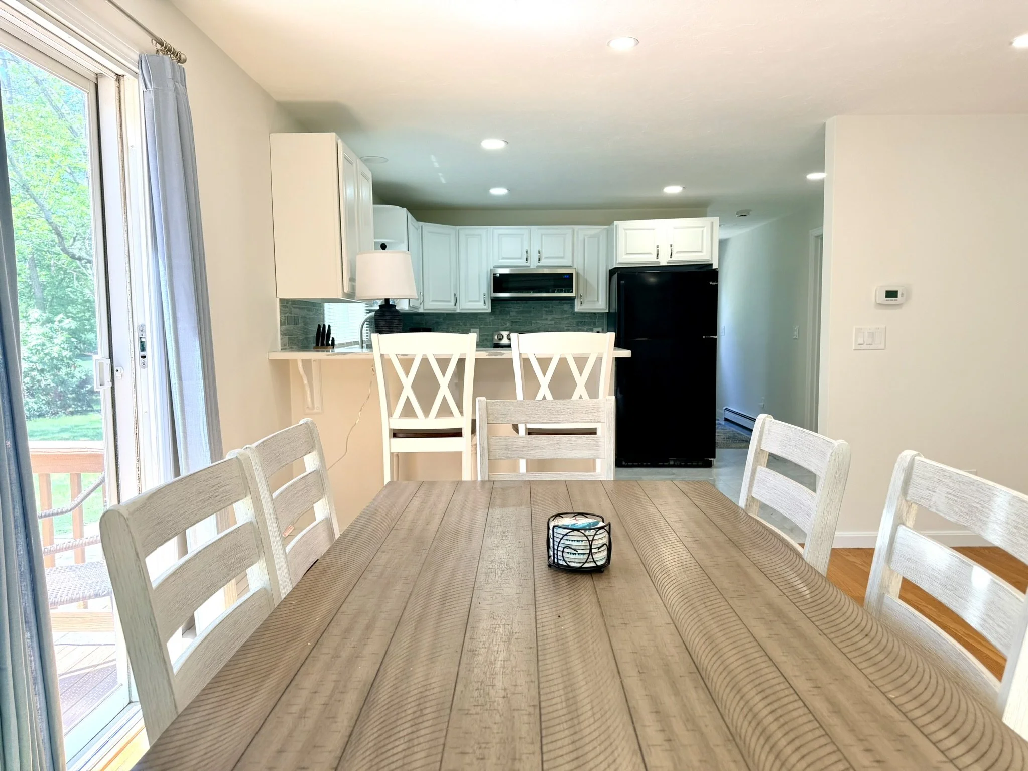 Cape Cod Vacation Rental Management | Tuxfin Hospitality Property - Dog-Friendly Falmouth Home for Short Term Bookings - Save Money over Airbnb & VRBO - Homeowners Rent Second Homes for Extra Income. Living Room. Close Up Dining Kitchen