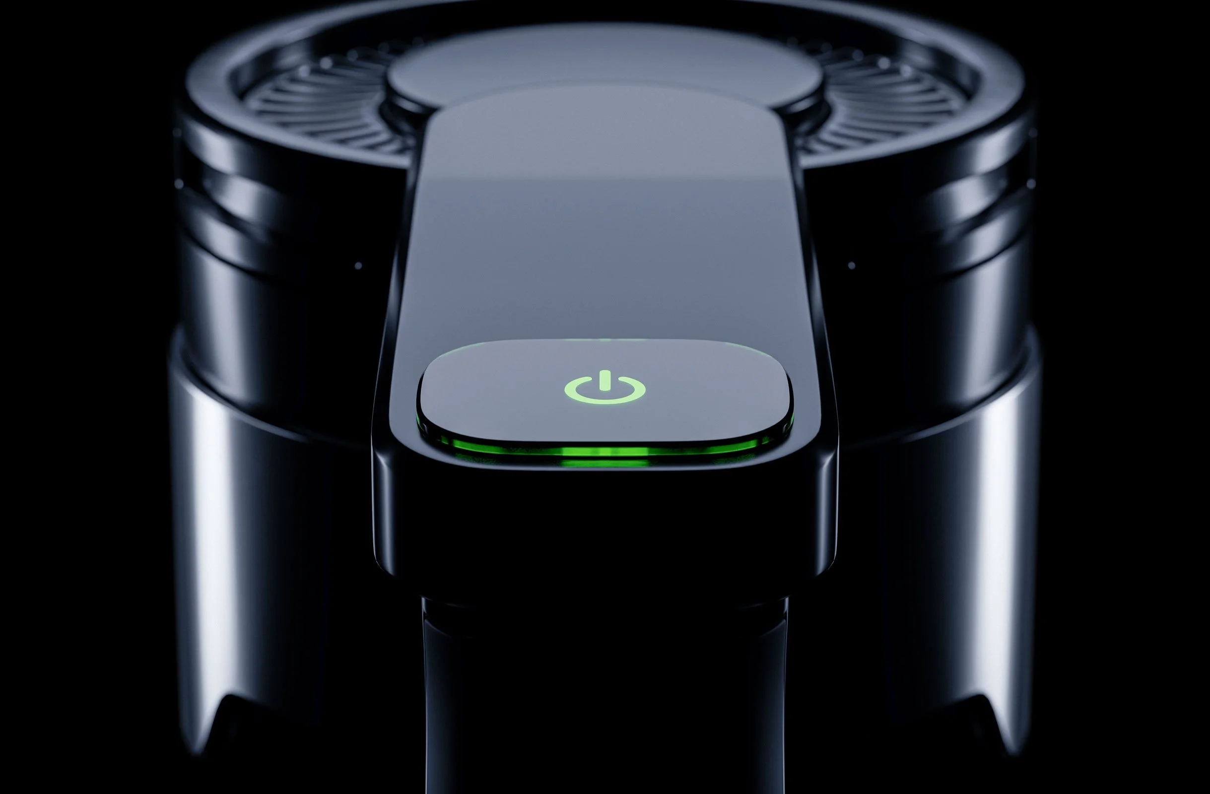 Close-up of a modern electronic device with a circular power button illuminated in green, surrounded by metallic components.