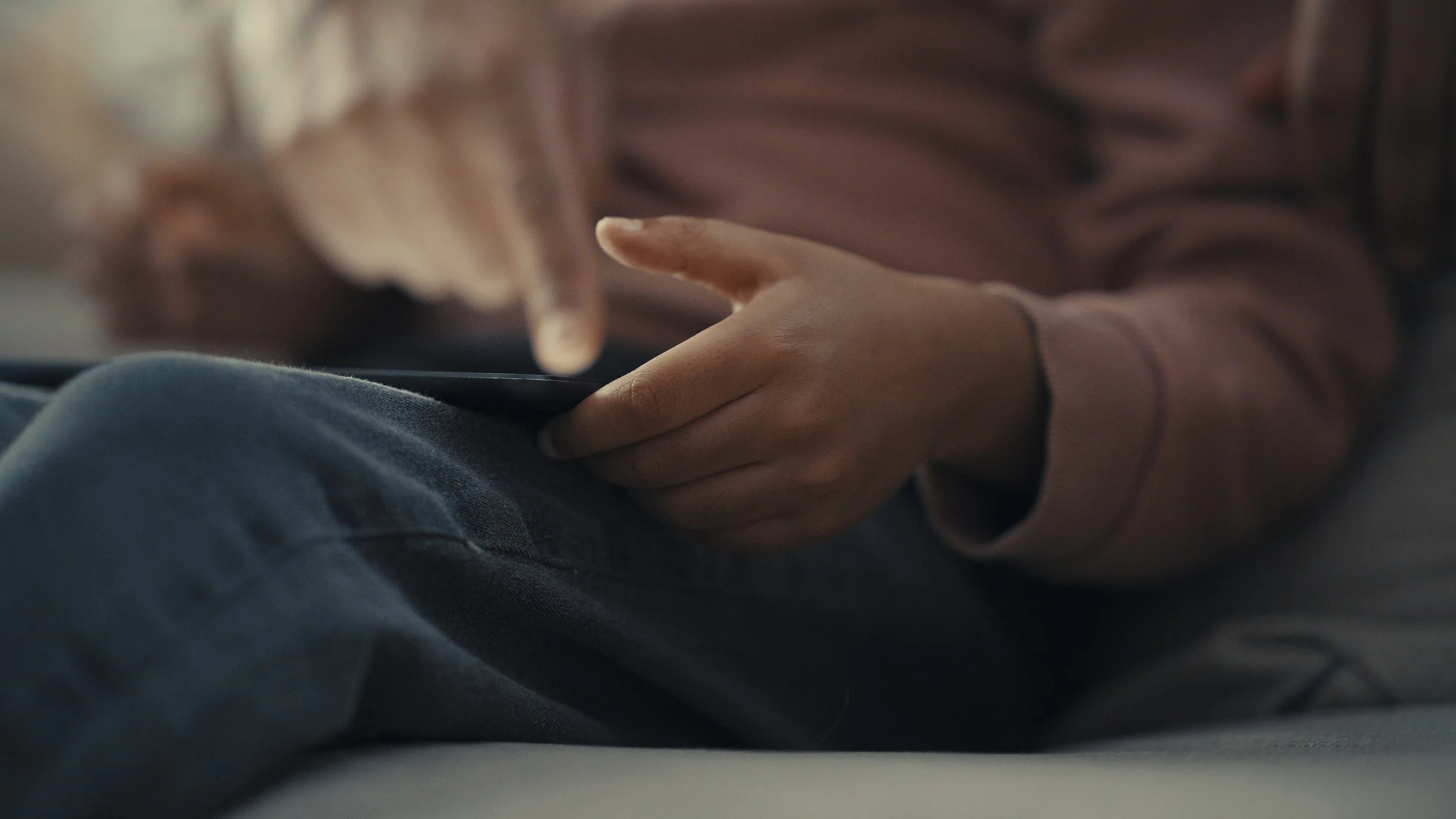 Person using a tablet while sitting.