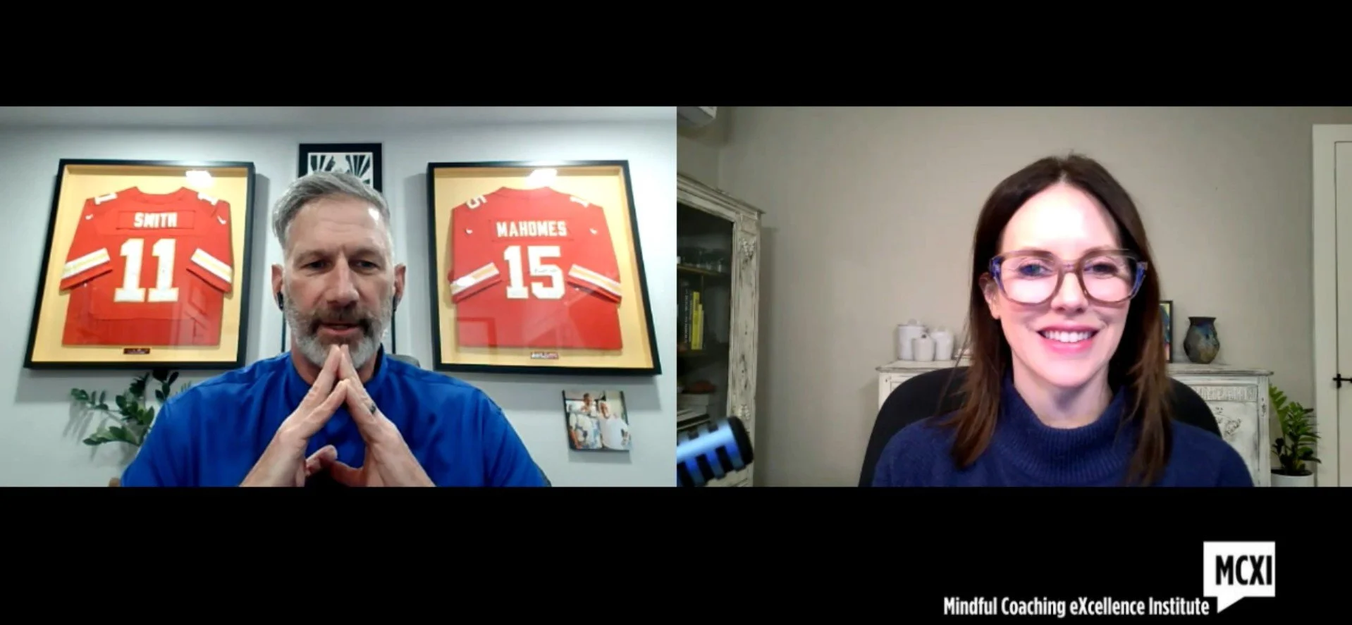 A man with a gray beard and blue shirt and a woman with glasses and brown hair smiling during a video call. Behind the man are framed sports jerseys of players Smith and Mahomes, and there is a microphone visible near the woman. The bottom right corner has a logo and the text "Mindful Coaching eXcellence Institute."